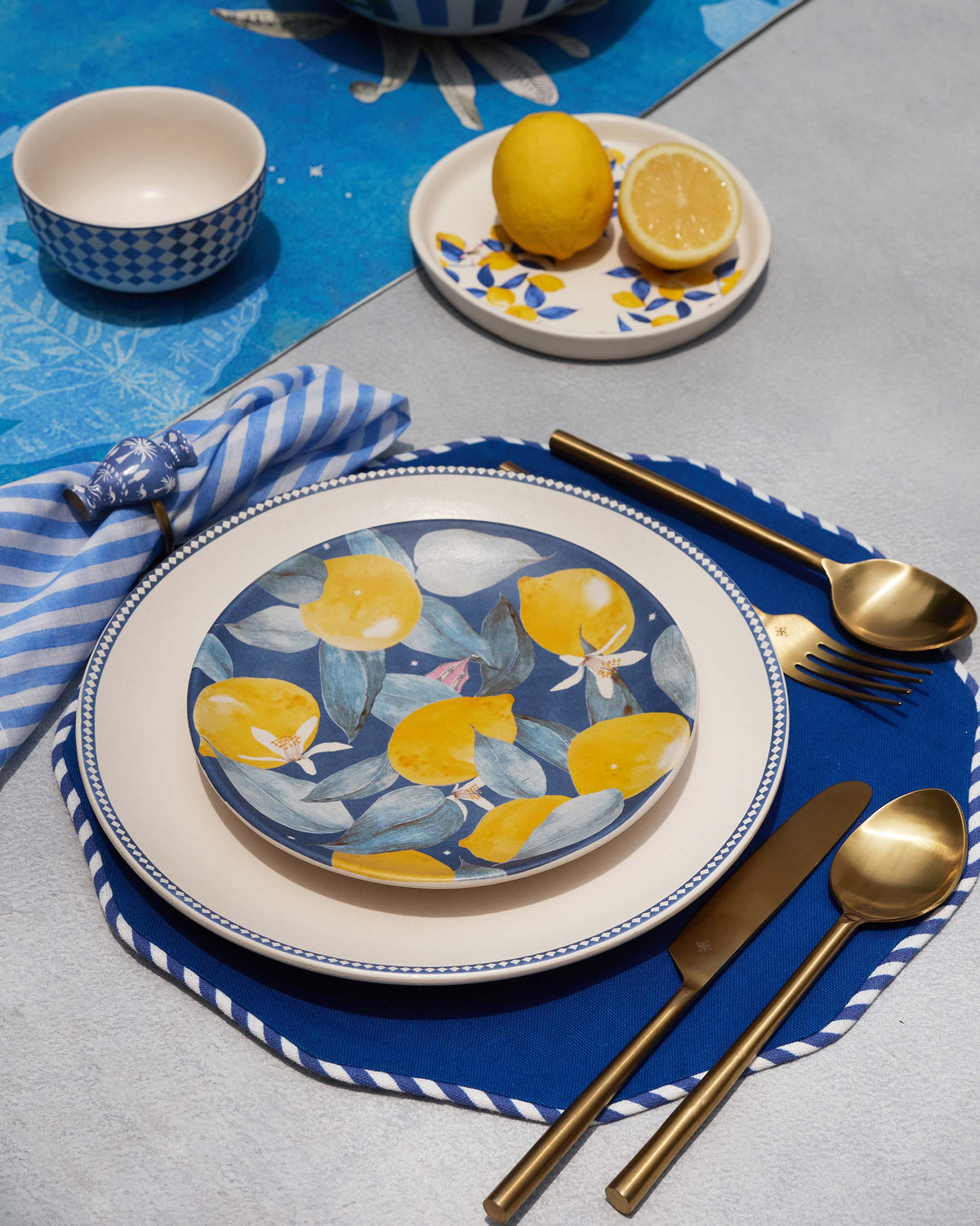Sahara place setting with a lemon side plate stacked on a cream dinner plate.