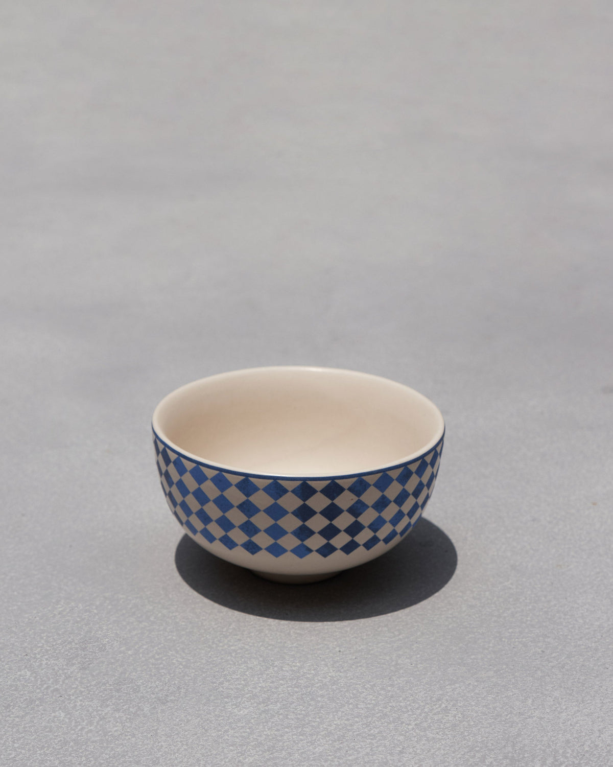 Sahara katori with a blue and white diamond checkered exterior.