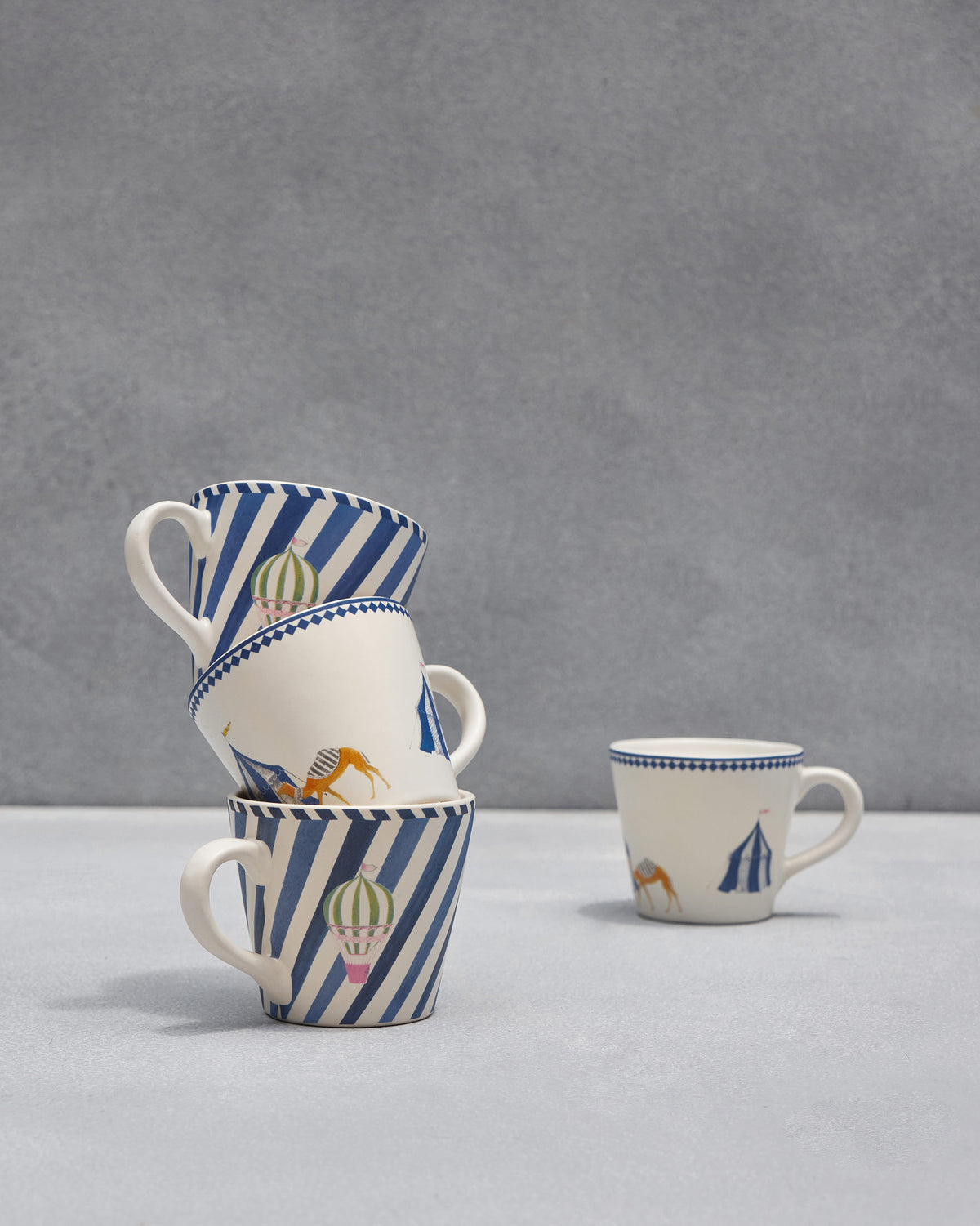 Sahara espresso mugs arranged to show tent, camel, and balloon prints.