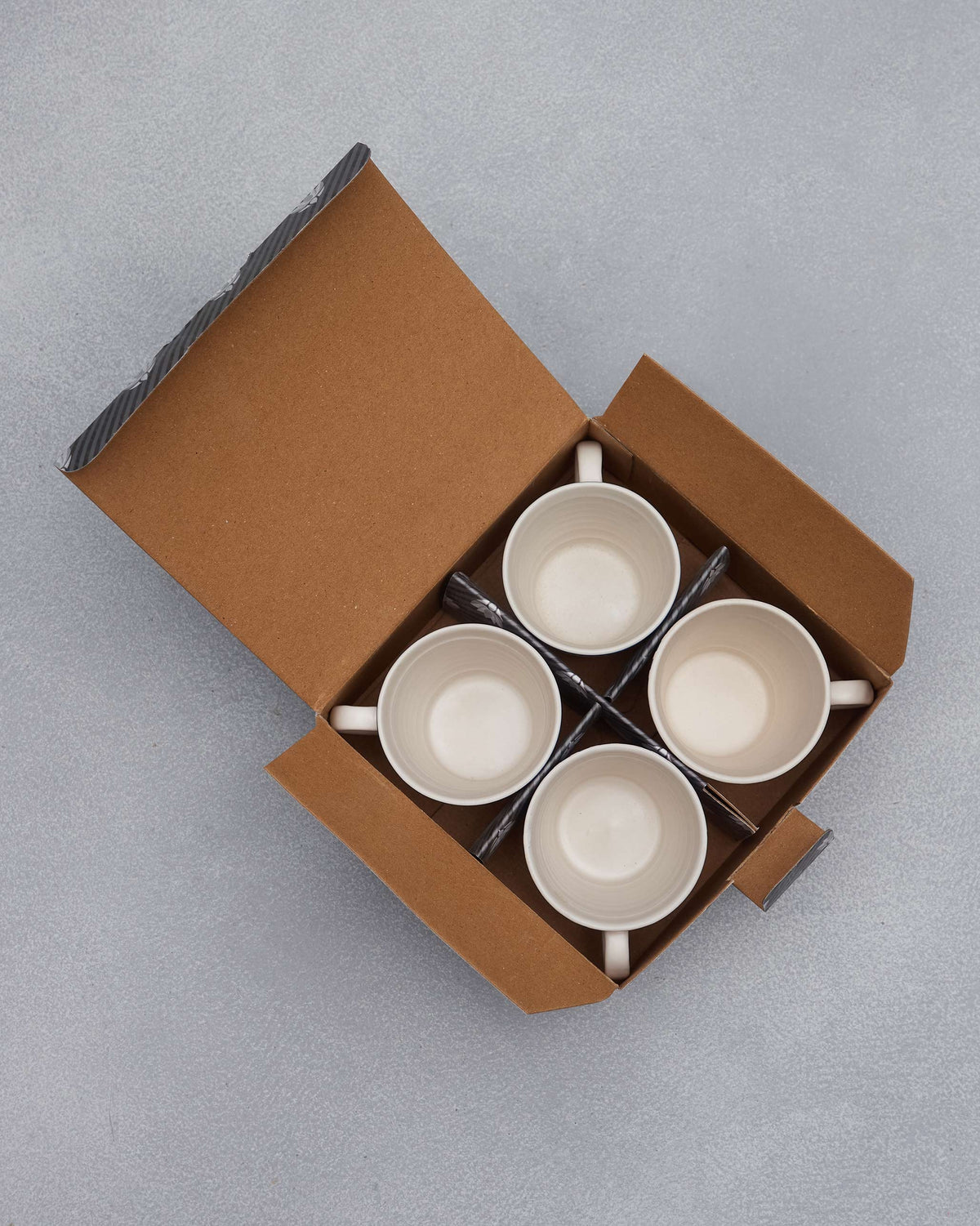Sahara espresso mug set of four packed in an open cardboard box.