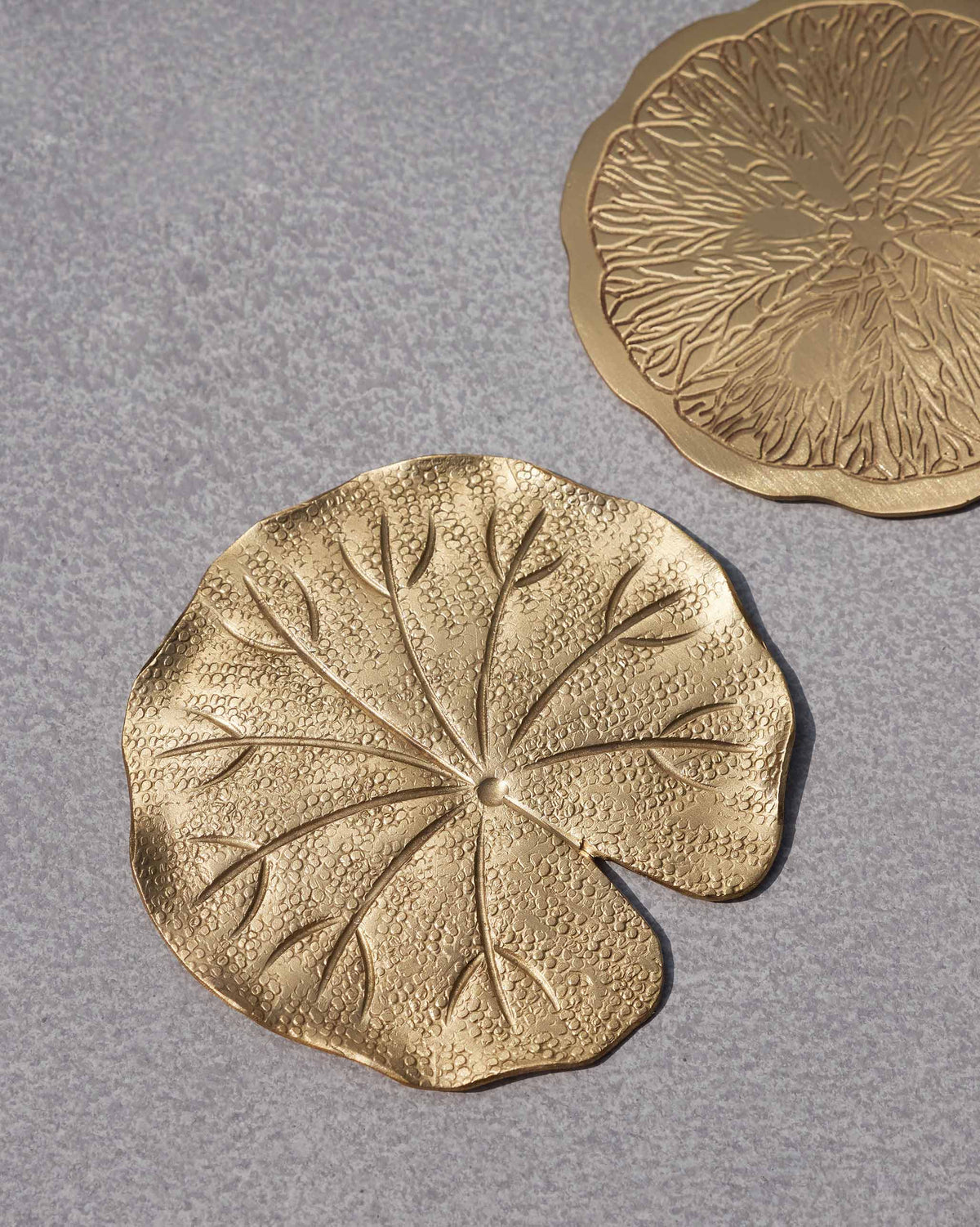 Close-up of a leaf-shaped Tangerine Coaster showing its raised veins.