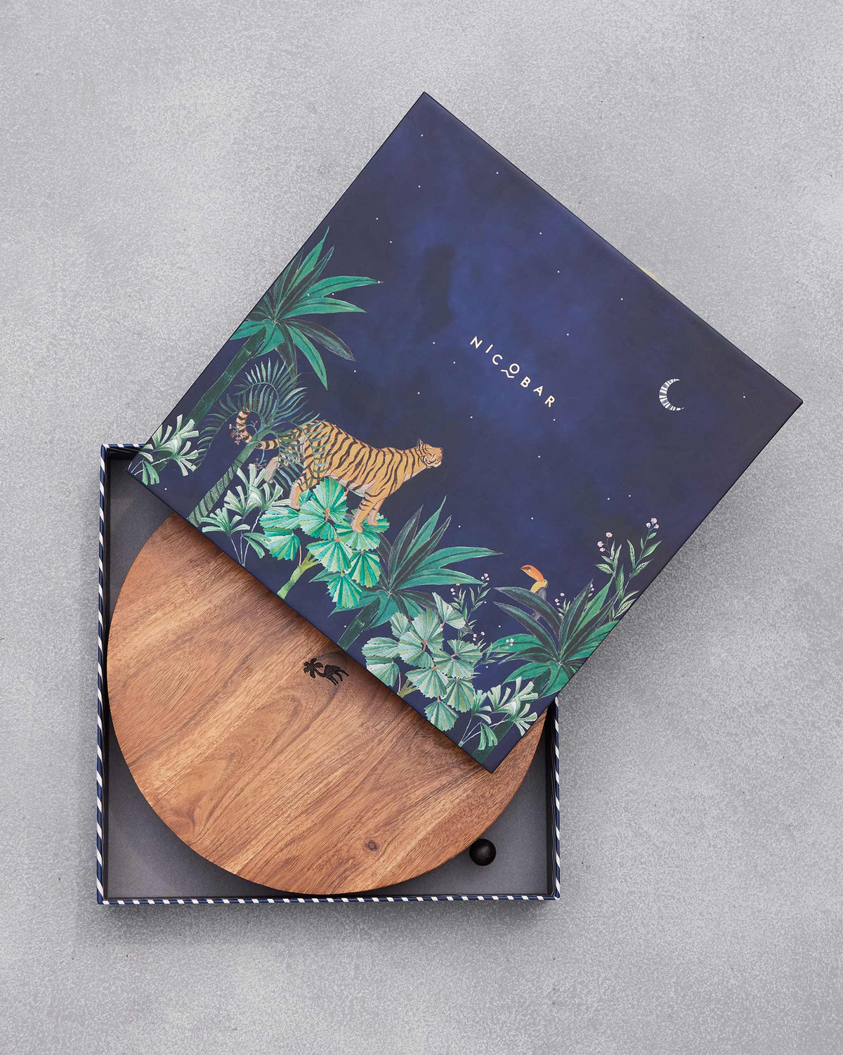 Navy lid with a tiger tipped off the Sahara cheese board set box.