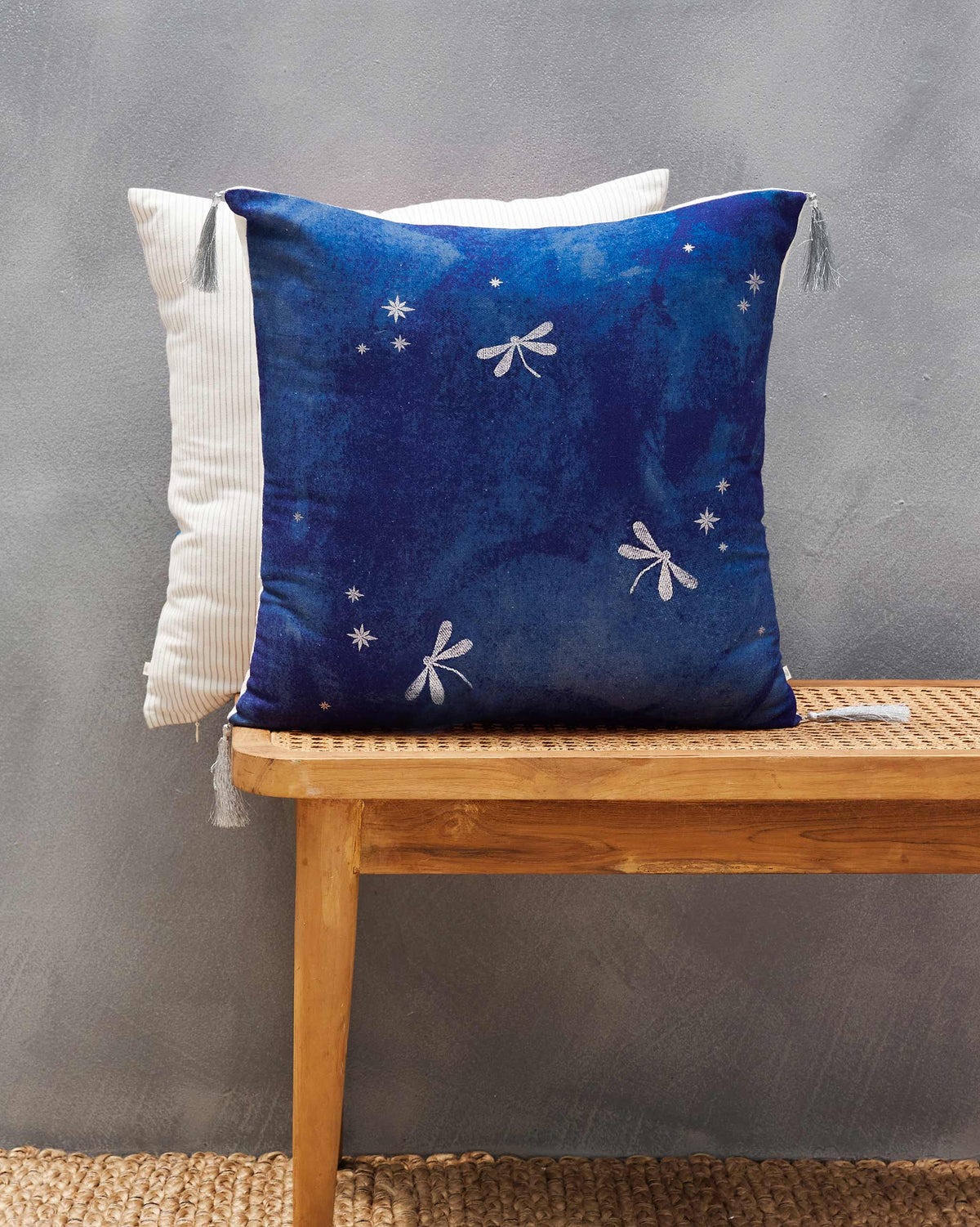 Azraq dragonfly cushion cover in navy with silver dragonflies and stars.