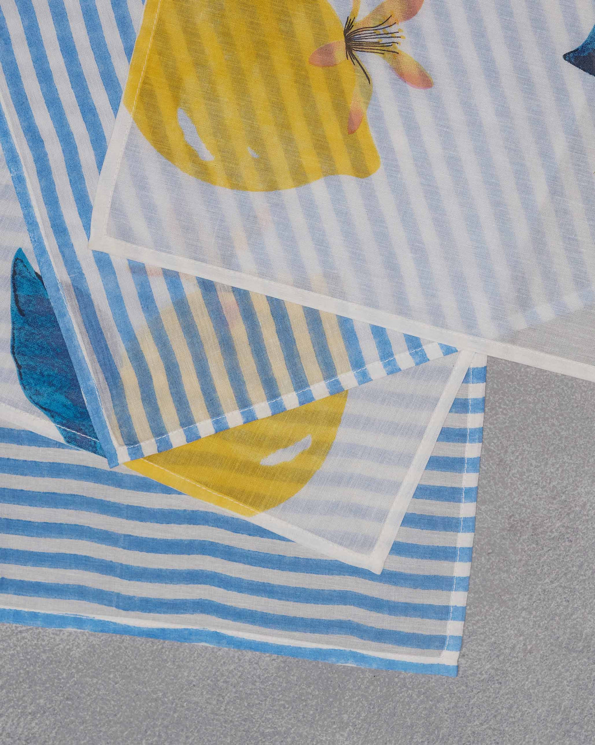 Close-up of an Azraq napkin with lemon print on blue stripes.