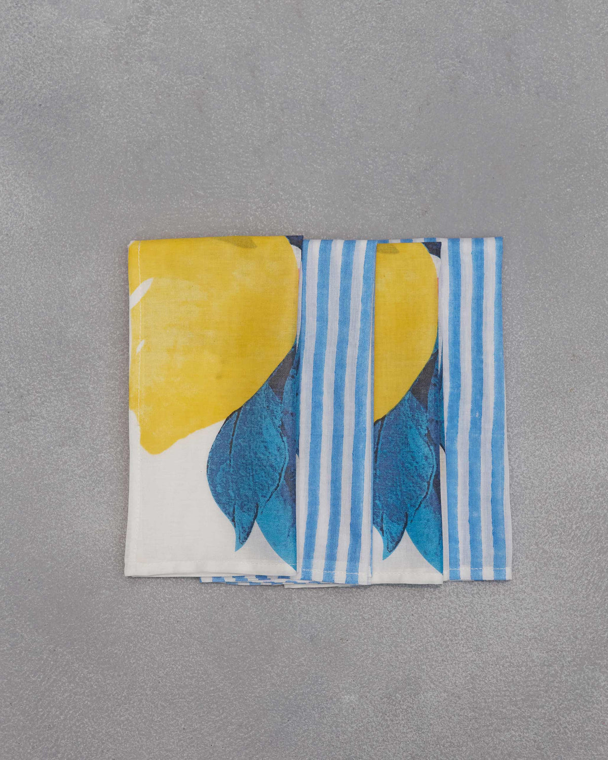Folded Azraq napkin showing lemon print and blue stripes.