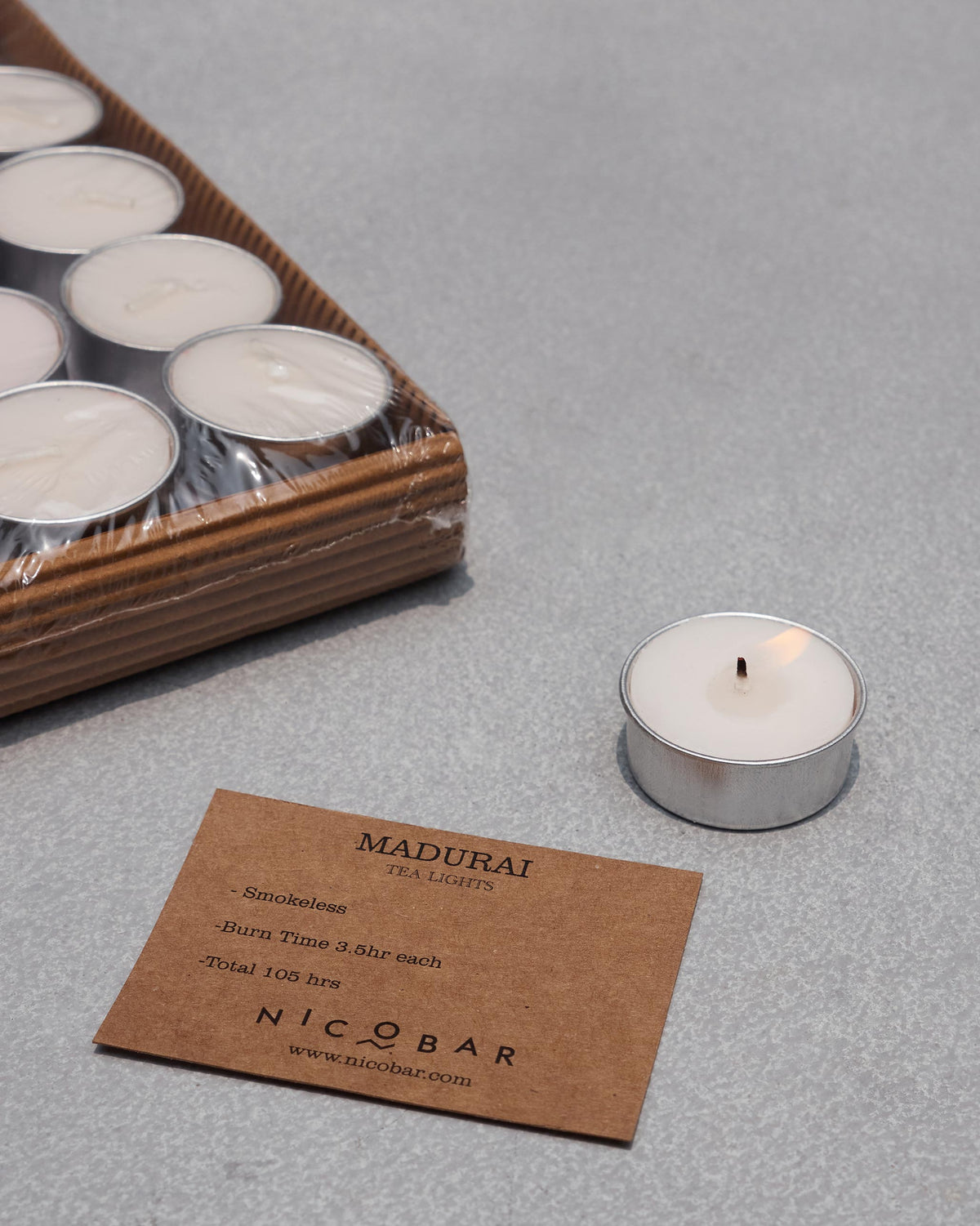 Lit Madurai tealight beside its product card and packaged set.