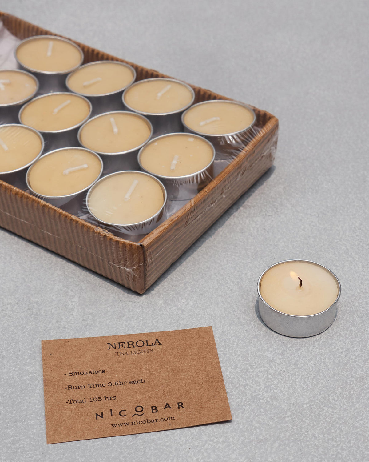 Nerola tealight pack beside a lit cream tealight and product card.