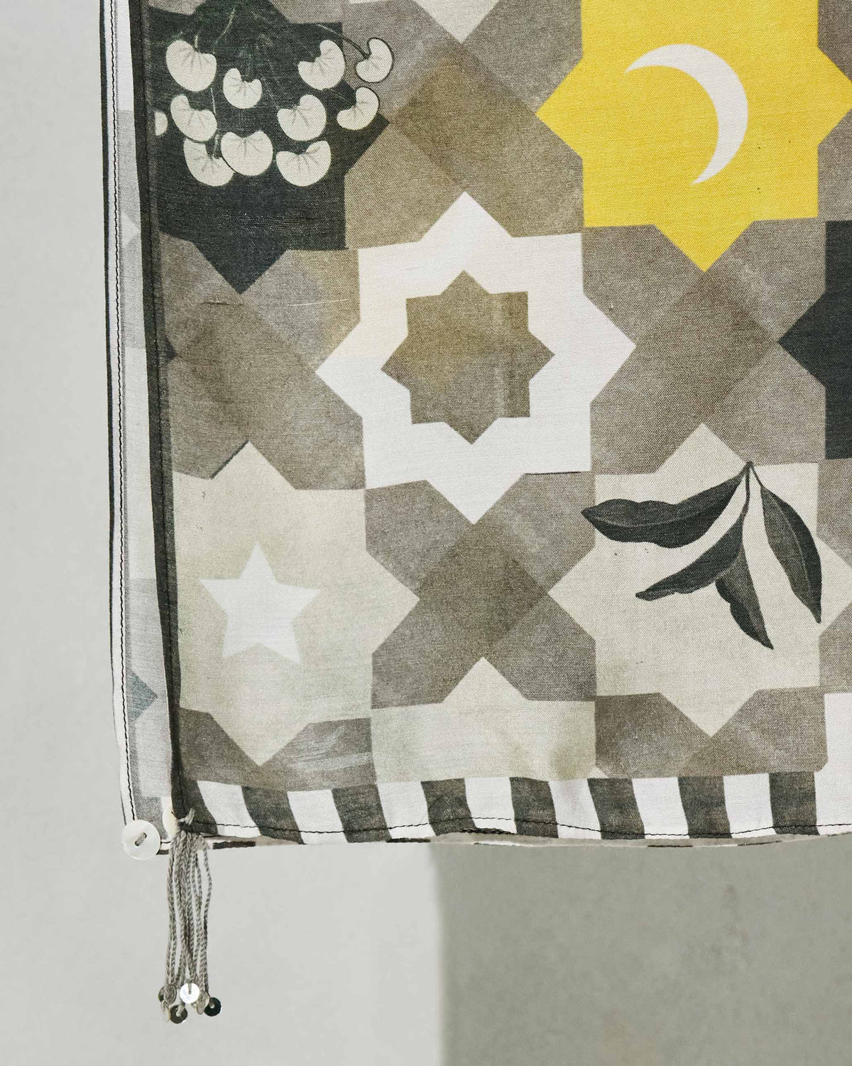 Close-up of the Celeste scarf corner showing a crescent moon and star tile print.