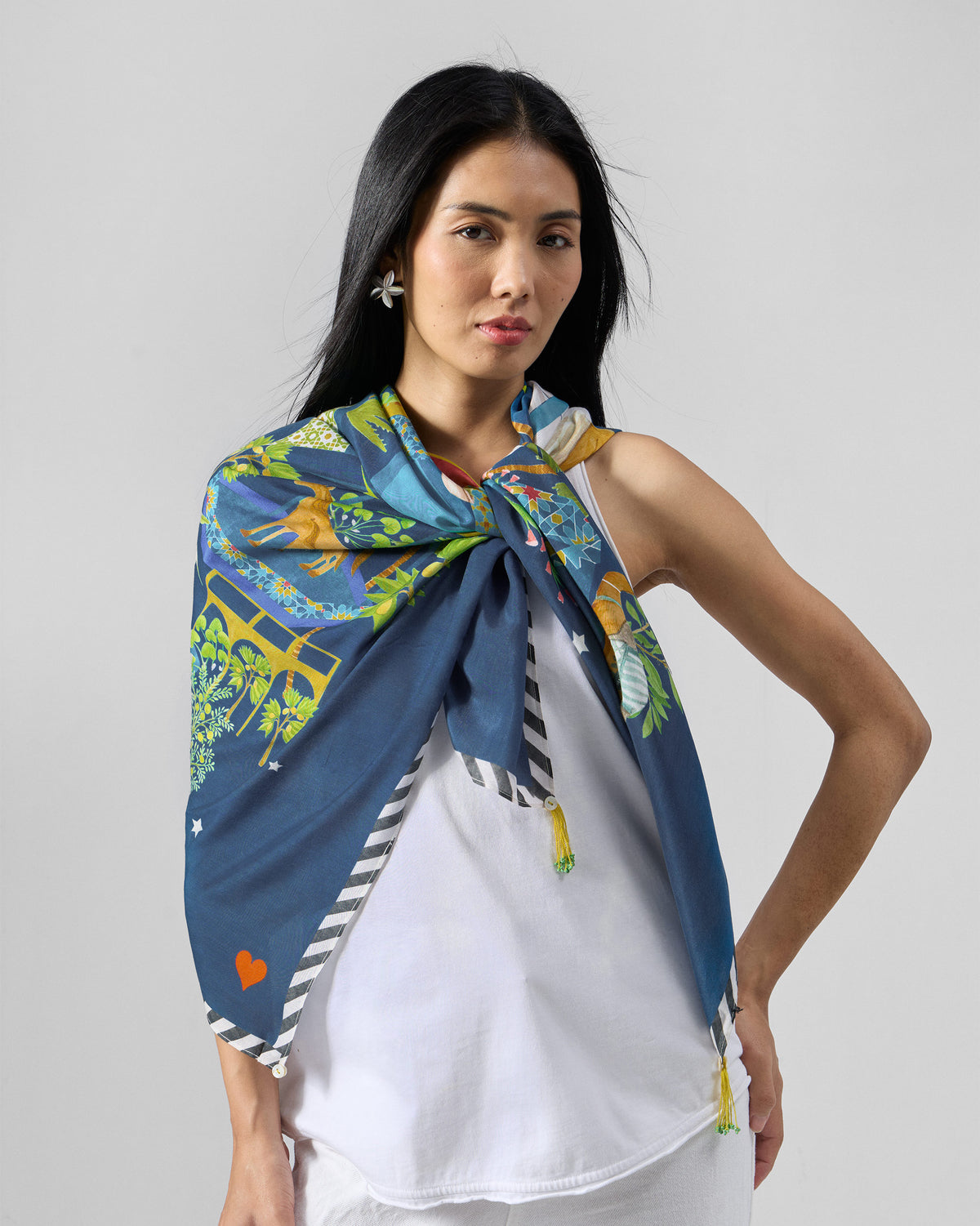 Person wearing a navy Midnight Carnival scarf with a striped edge.