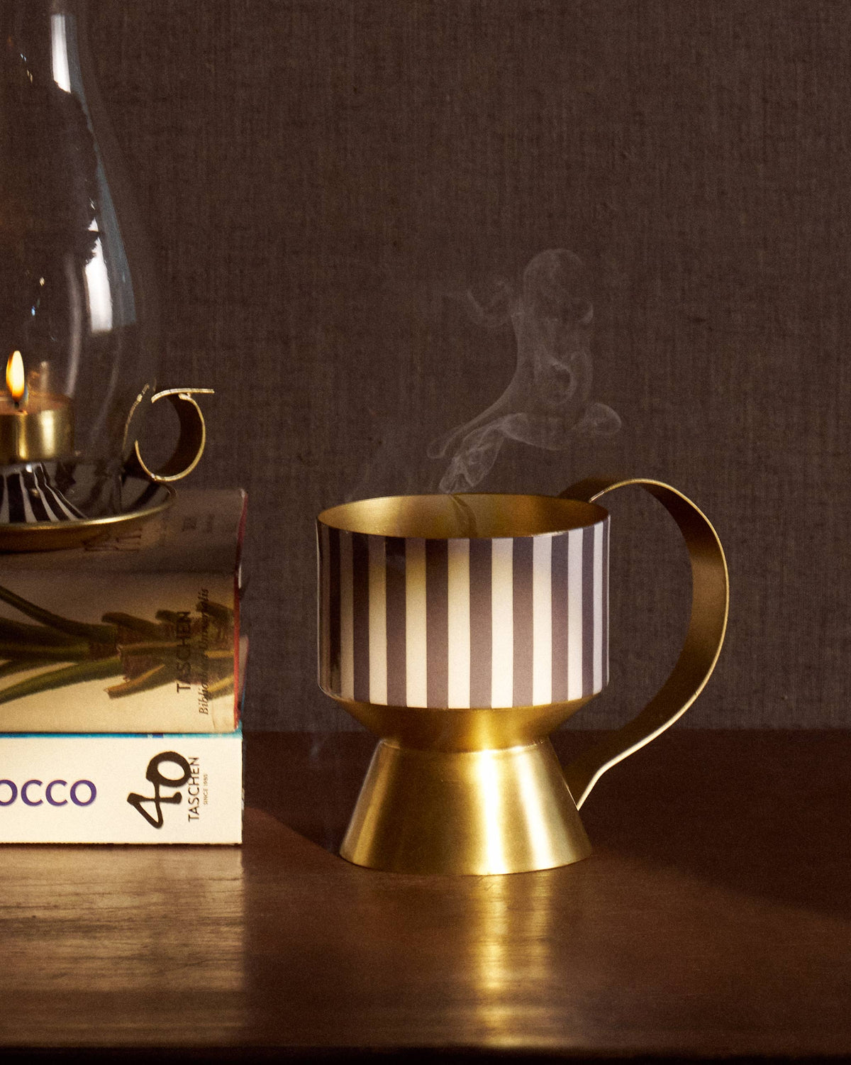 Dune dhuna with black-and-white stripes and a gold handle, smoking gently.