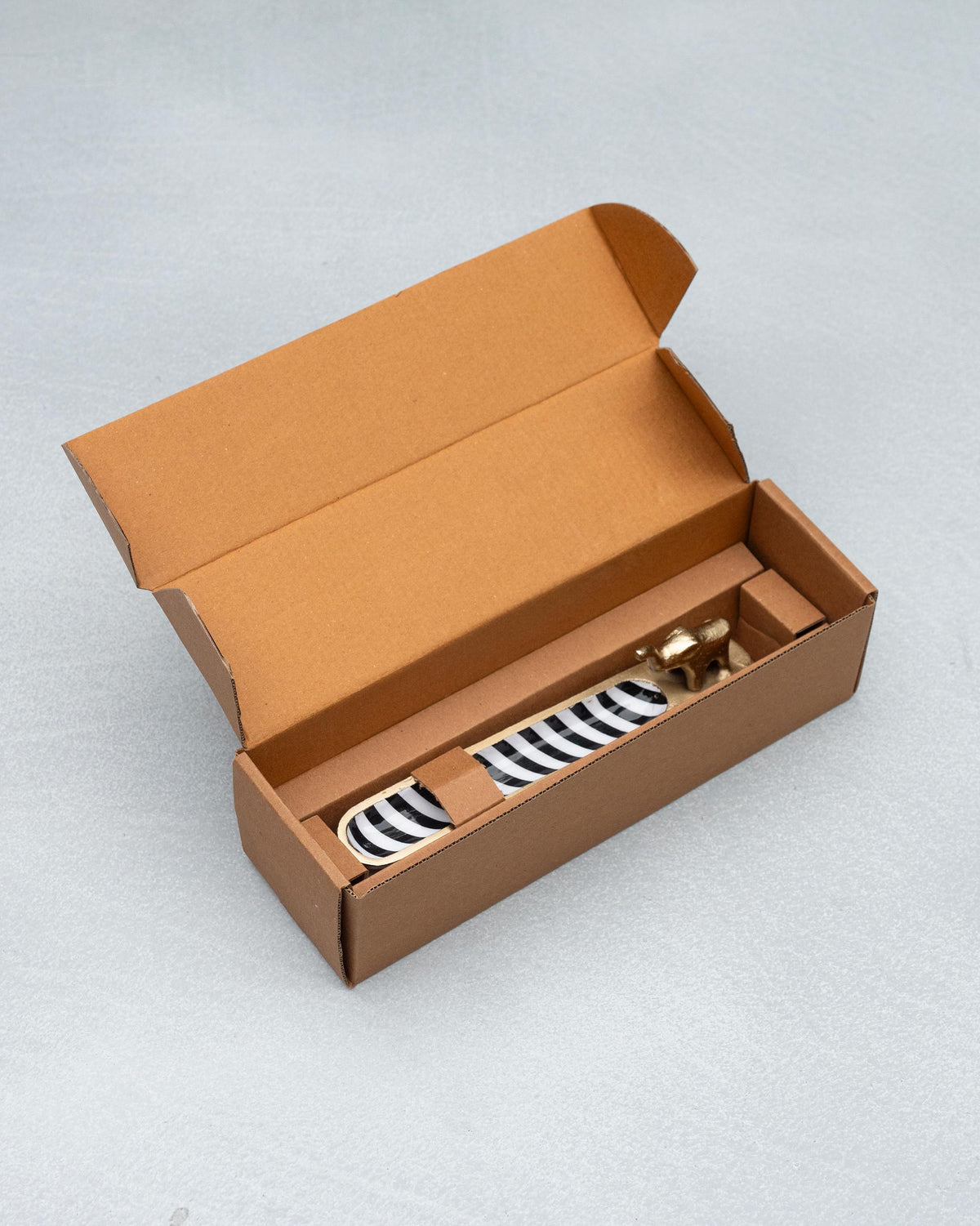 Haathi incense holder packed in an open brown gift box.