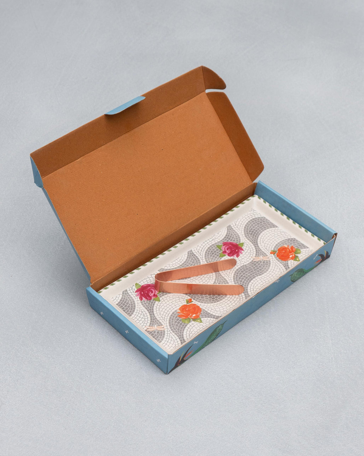 Mosaic Bloom cookie tray and copper tongs inside an open blue gift box.