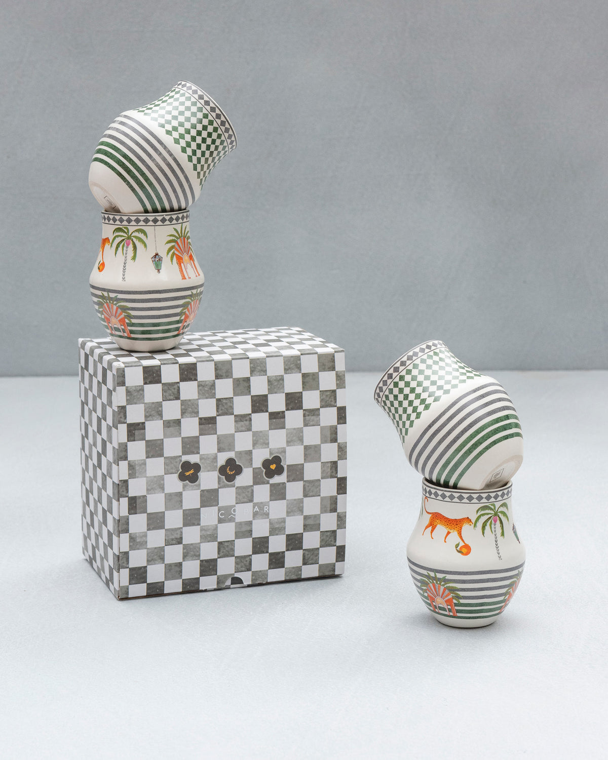 Dessert Palm Kulhars with palm trees and tigers, one stacked on a checkered box.