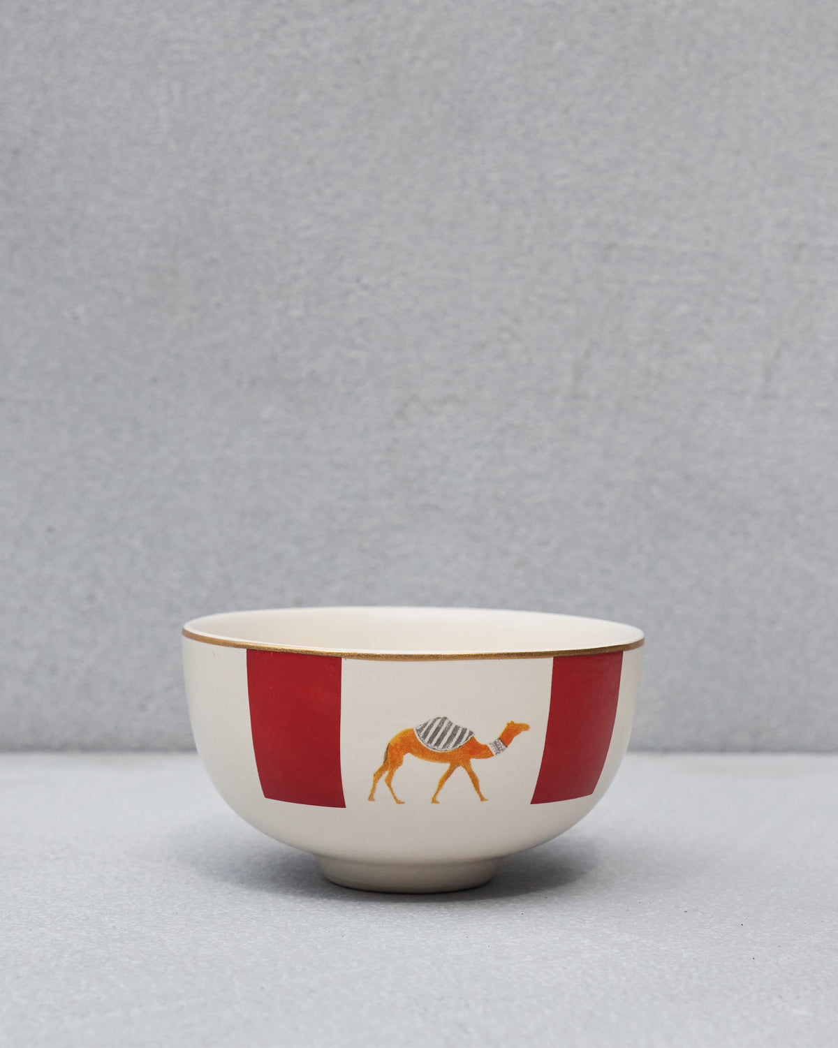 Desert Trail katori with an orange camel between red blocks.