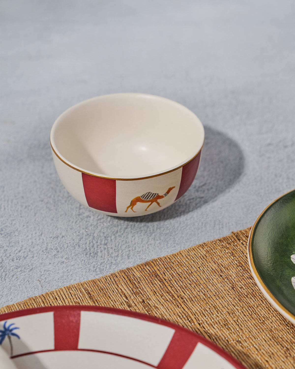 Desert Trail katori with camel motif set on a woven placemat.