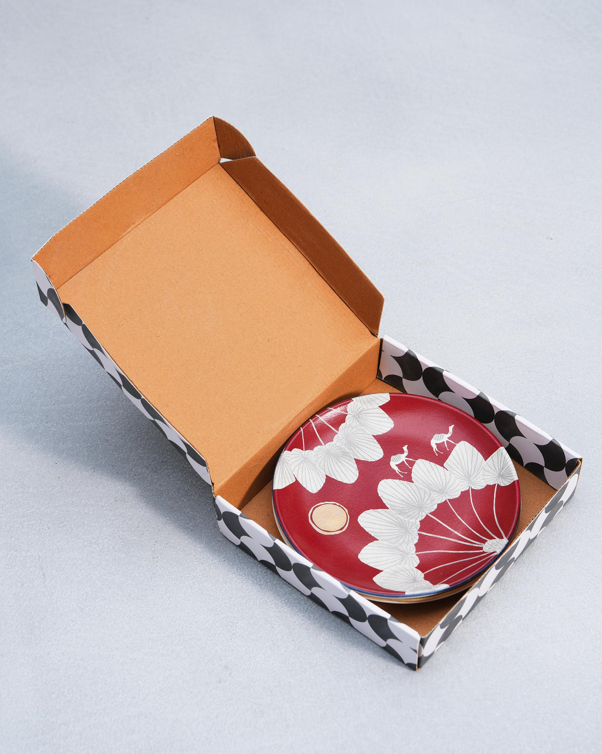 Red Desert Trail quarter plates packed in an open black-and-white patterned gift box.