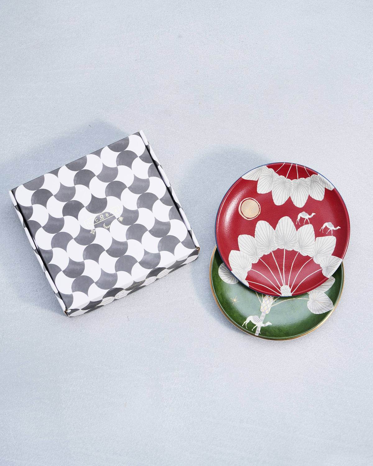 Desert Trail quarter plates beside a black-and-white Nicobar patterned gift box.