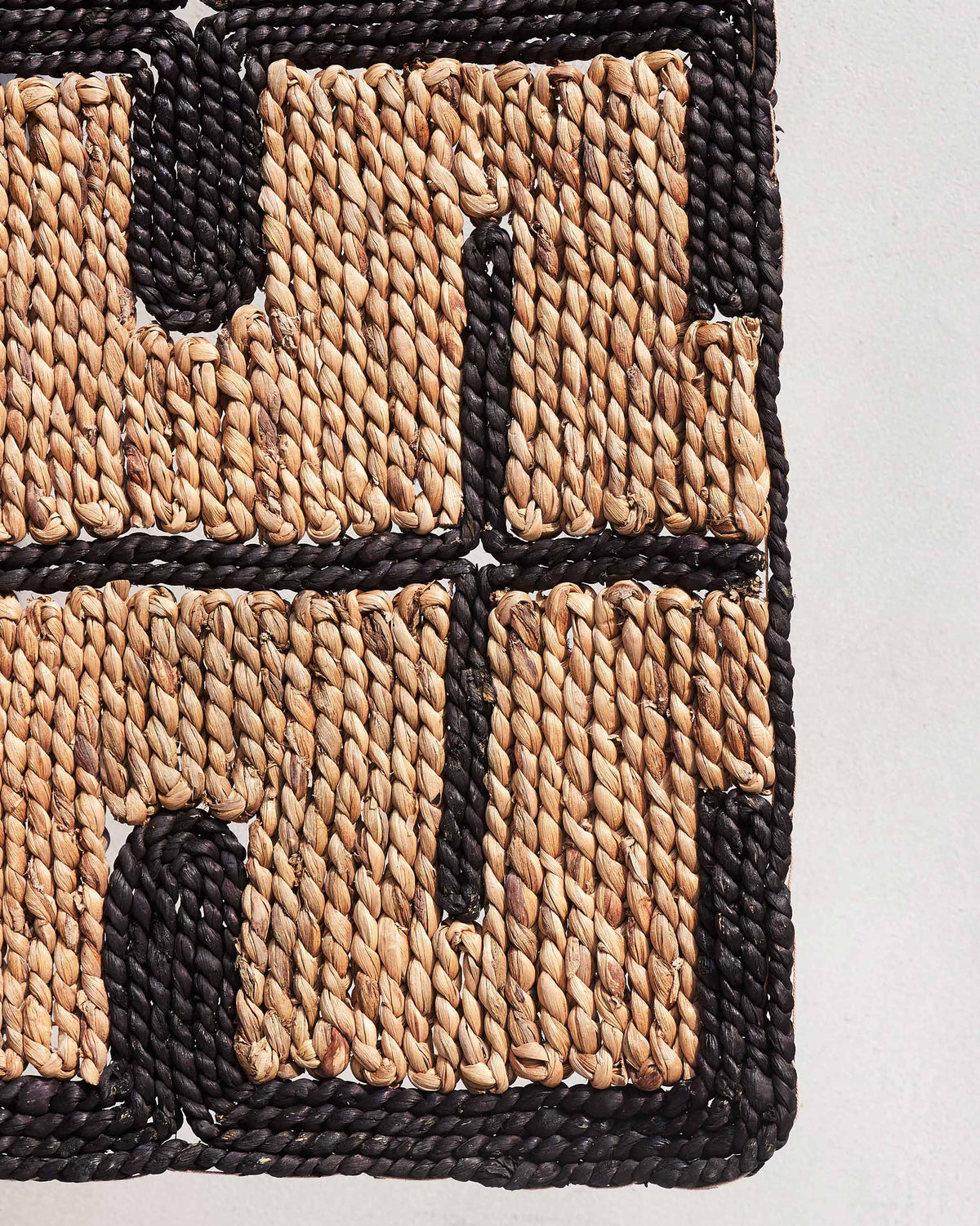 Close-up of a Marrakesh floor rug corner showing its black edging.