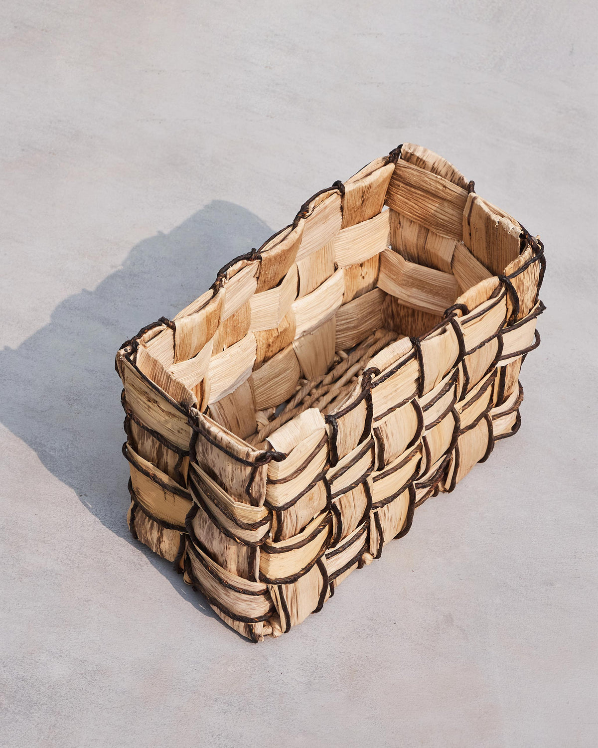 Overhead view into an empty small Mosaic basket.