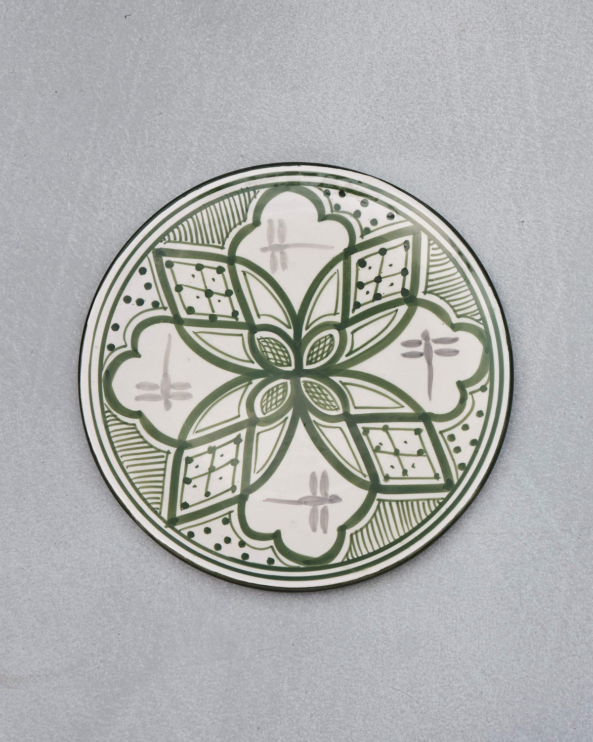 Overhead view of the Mosaic Oasis Quarter Plate in green and white with a flower motif.