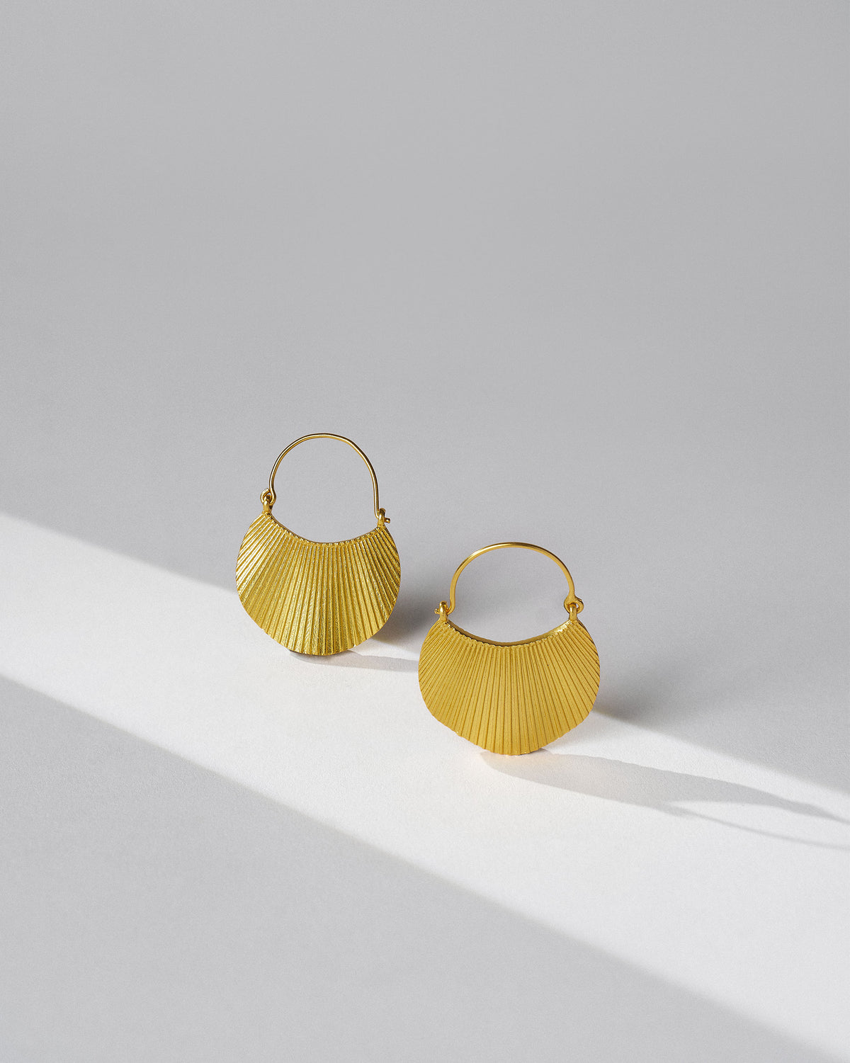 Pair of gold Pankha fan balis with pleated texture.