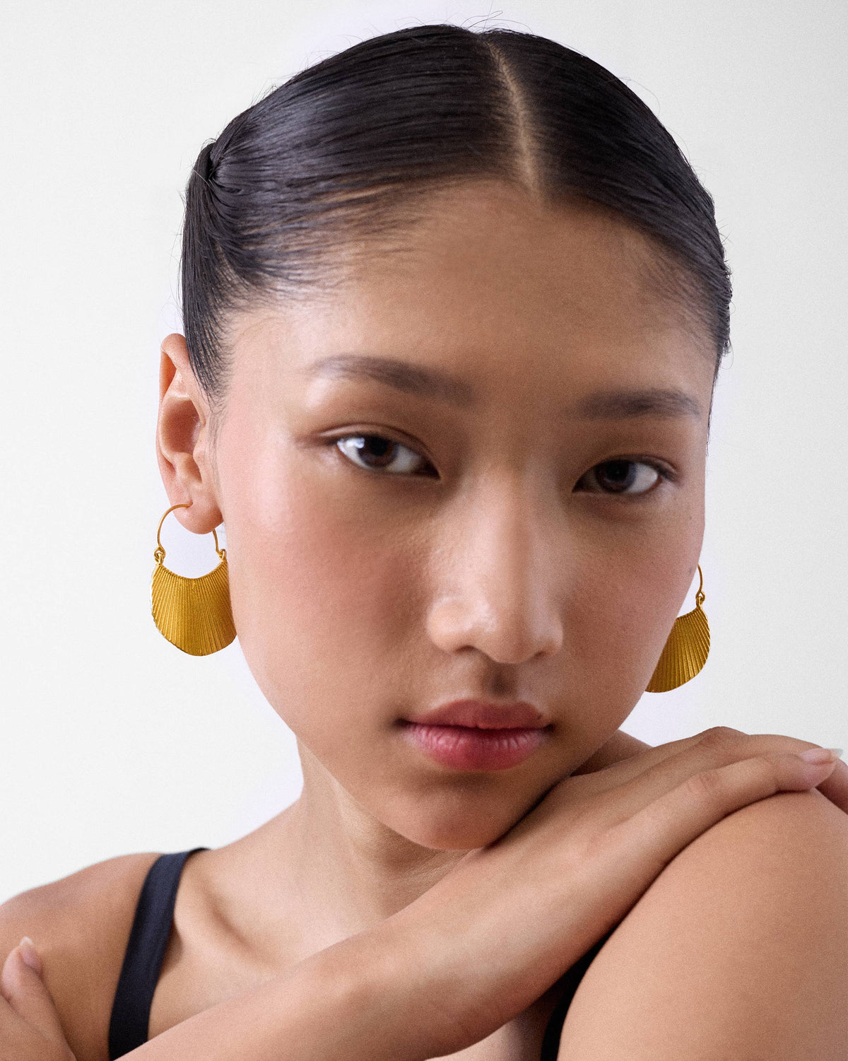 Person wearing gold Pankha fan balis.