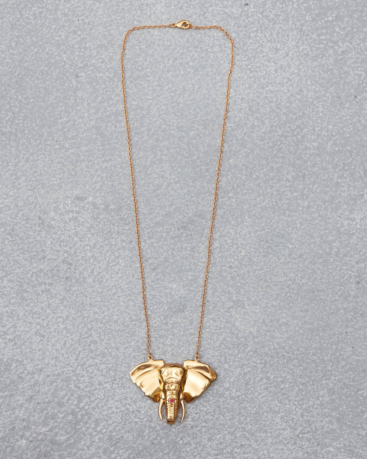 Haathi Necklace with an elephant-head pendant laid flat on a grey surface.