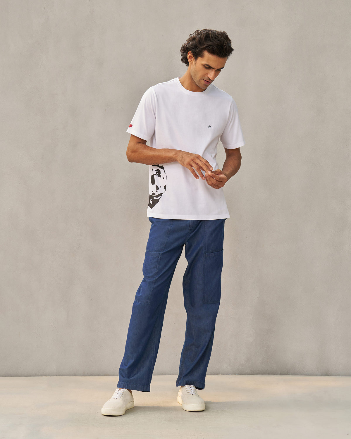 Person wearing a white Peekaboo Dalmation T-shirt with a Dalmatian side print.