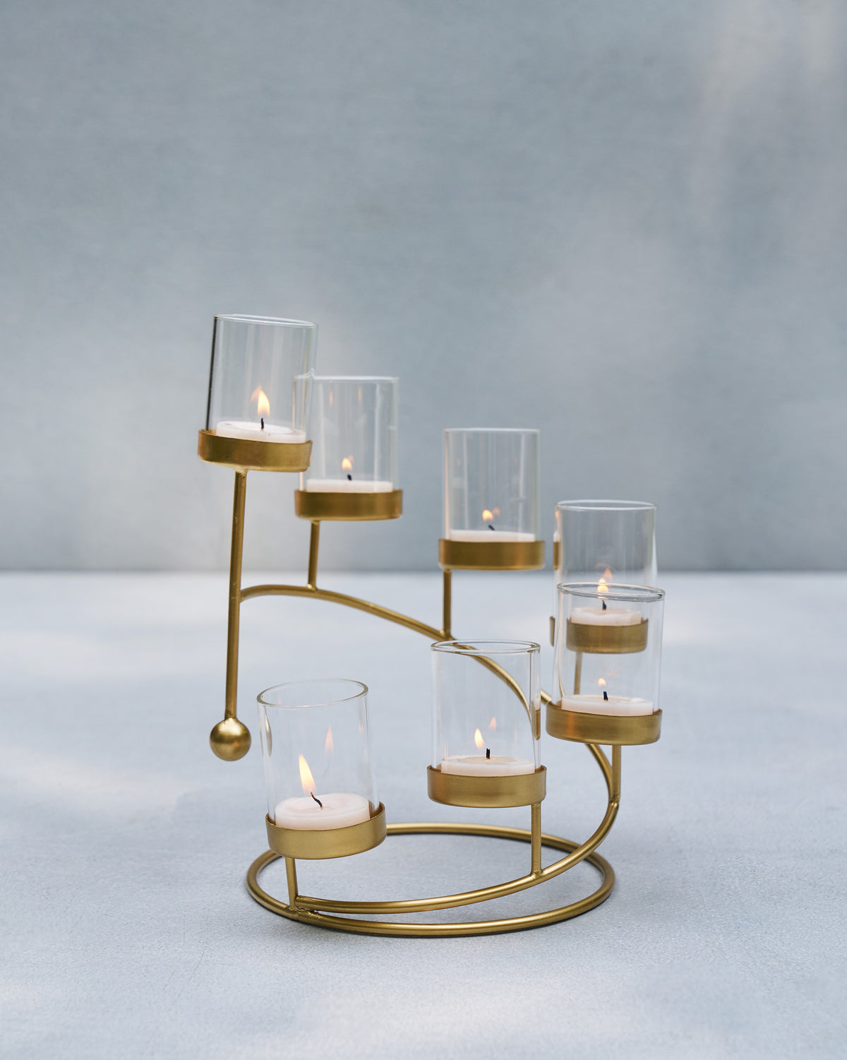 Amaryllis Tealight Holder with lit tealights in its glass cups.