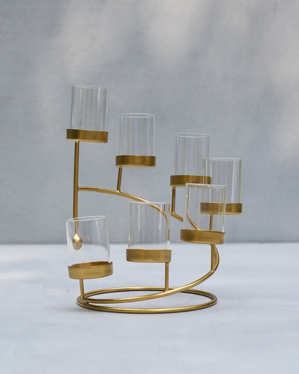 Amaryllis Tealight Holder with glass cups on curved gold arms.