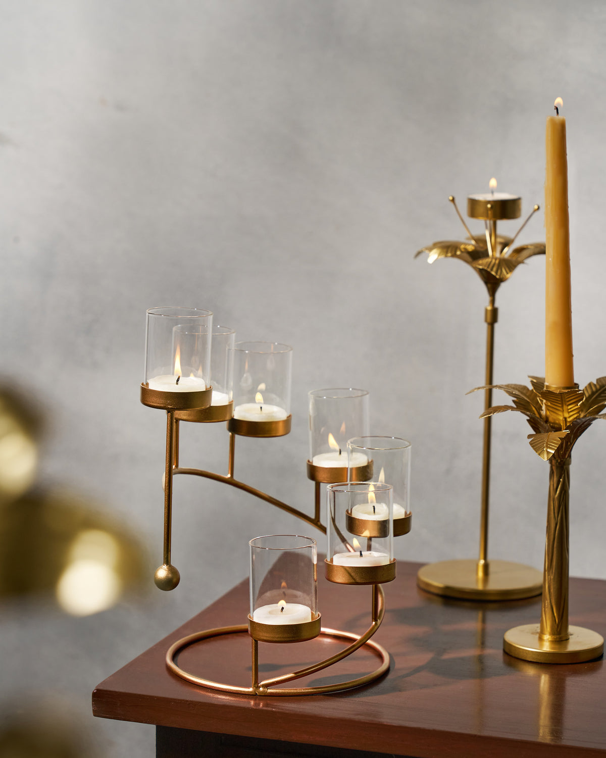Amaryllis Tealight Holder with lit tealights, shown in a styled setting.