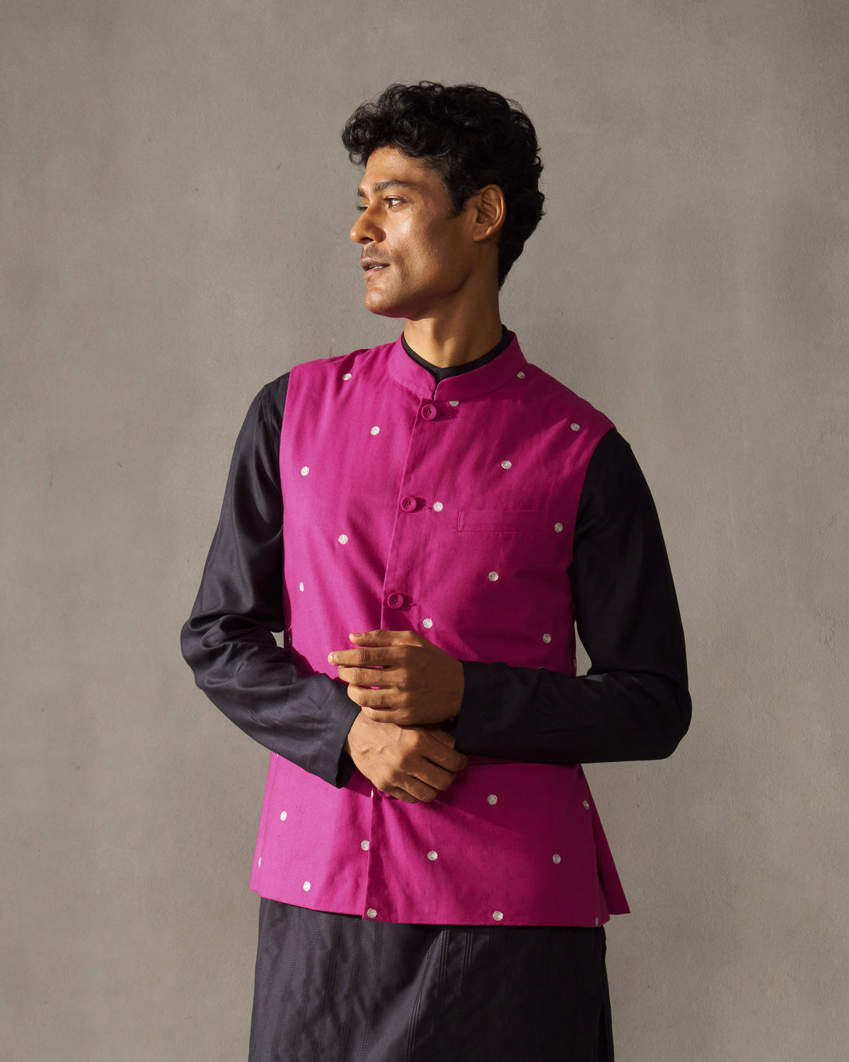 Magenta Nehru jacket with silver embroidery worn at a three-quarter angle.