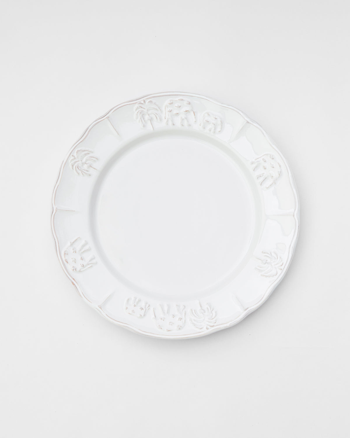 Ele Palm Dinner Plate in white with embossed palms and elephants around the rim.