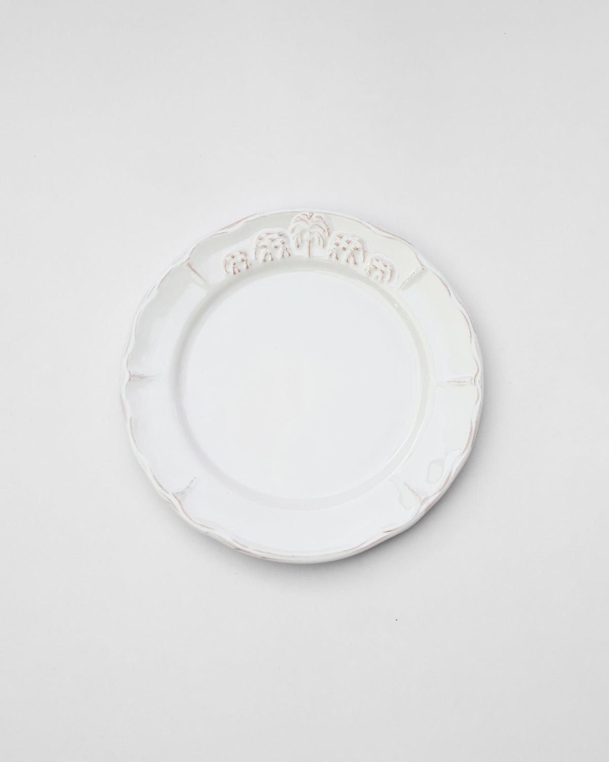 White Ele Palm quarter plate with embossed elephants and a palm.