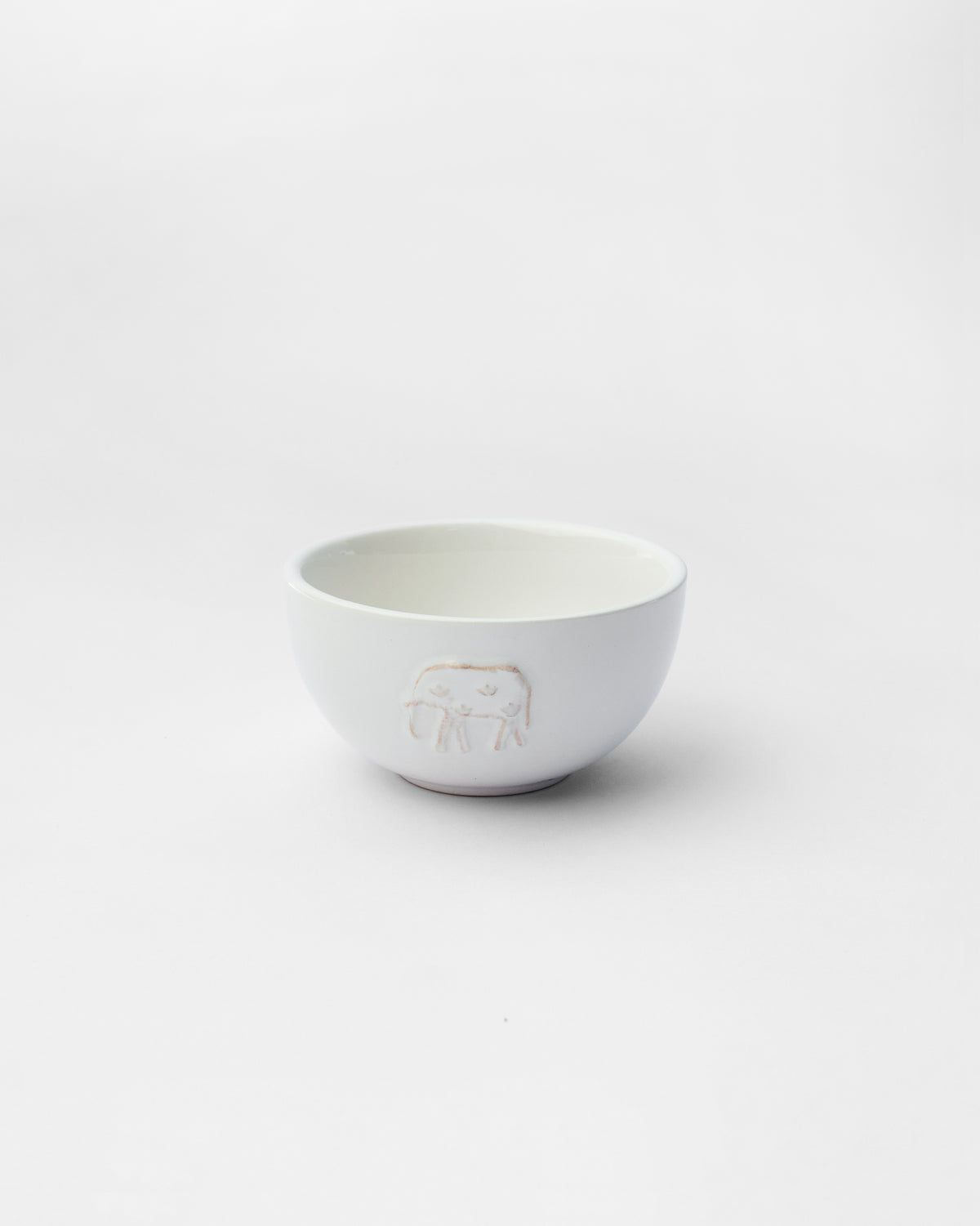 Ele Palm Katori in white with an embossed elephant on its side.