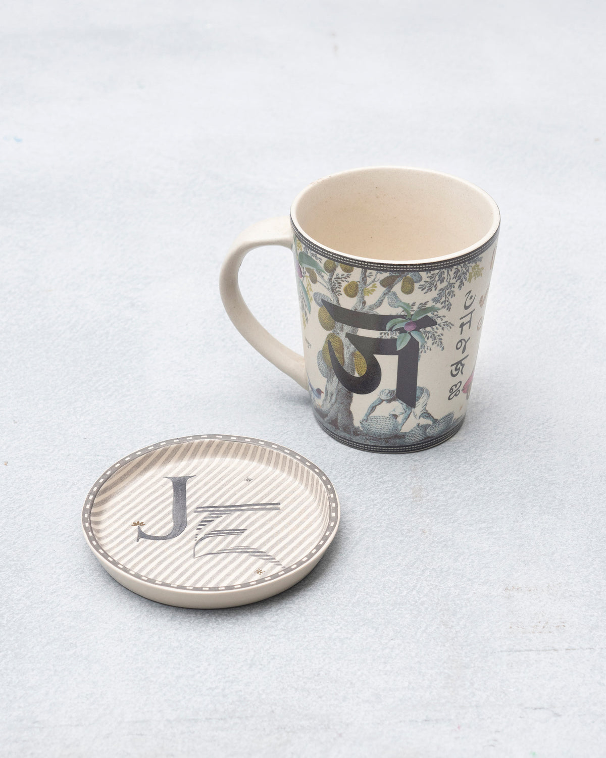 J Alphabet mug with Devanagari ज and fruit tree beside a letter J coaster.