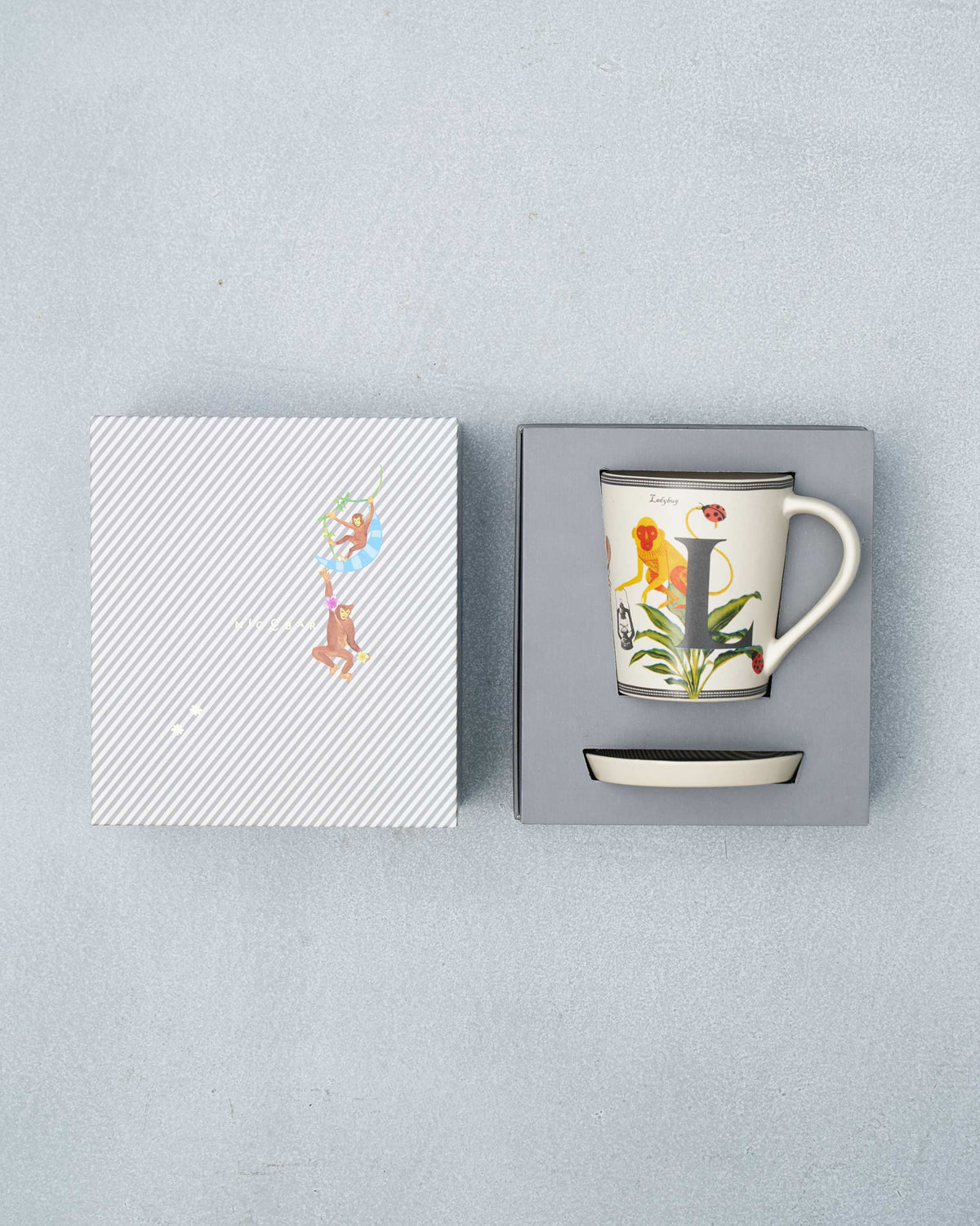 L alphabet mug and coaster packed in an open gift box.