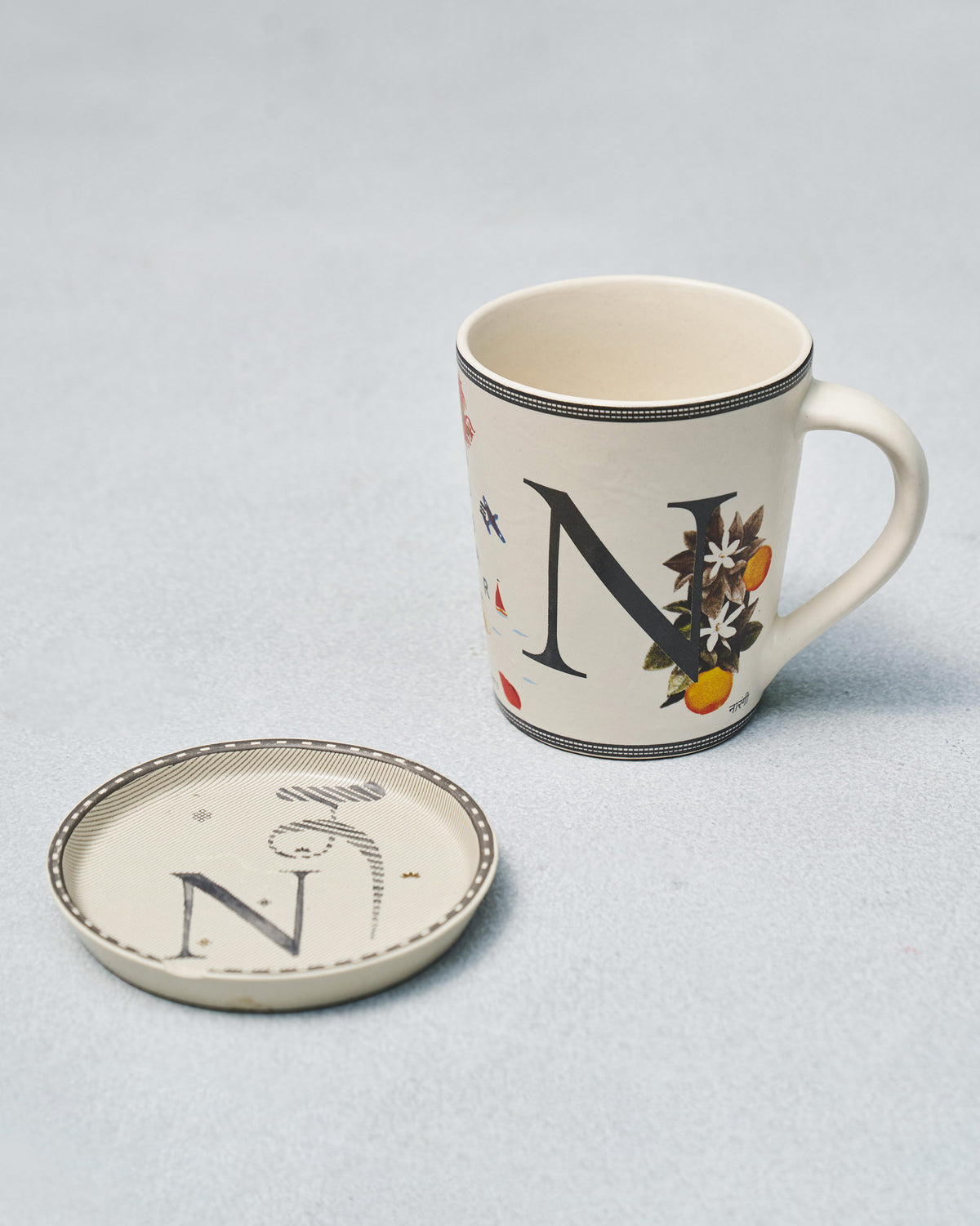 Cream N alphabet mug with citrus print paired with a matching N coaster.