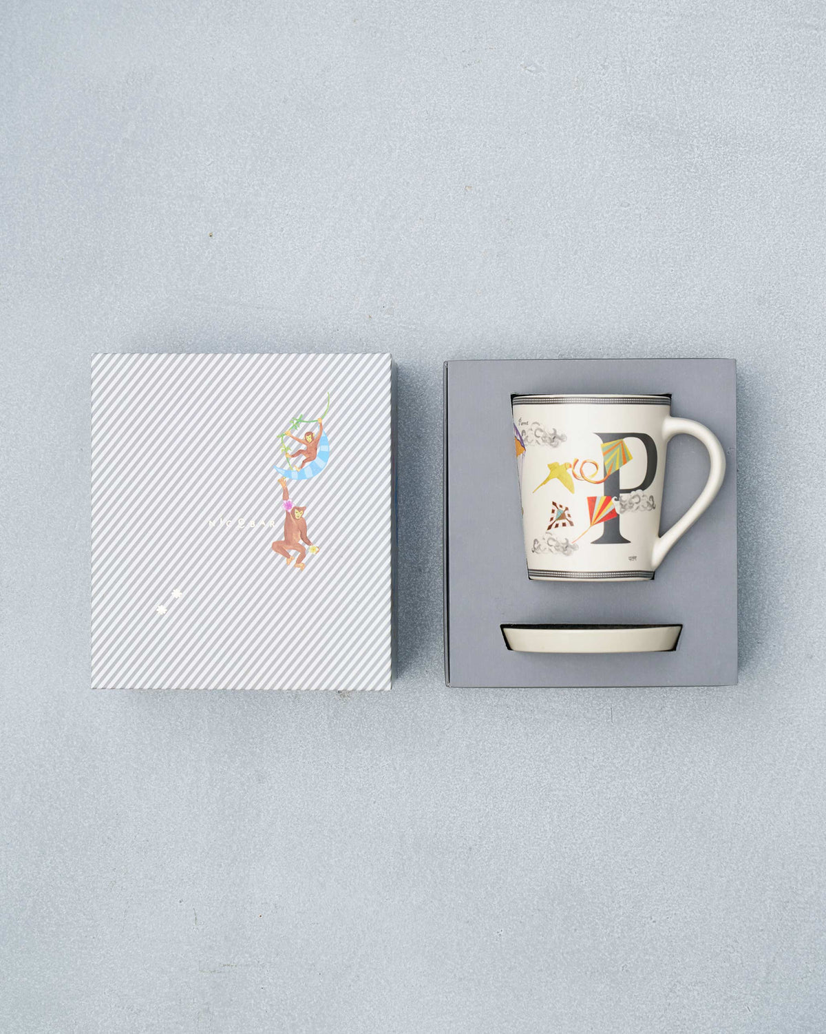 P alphabet mug and coaster packed in an open striped gift box.