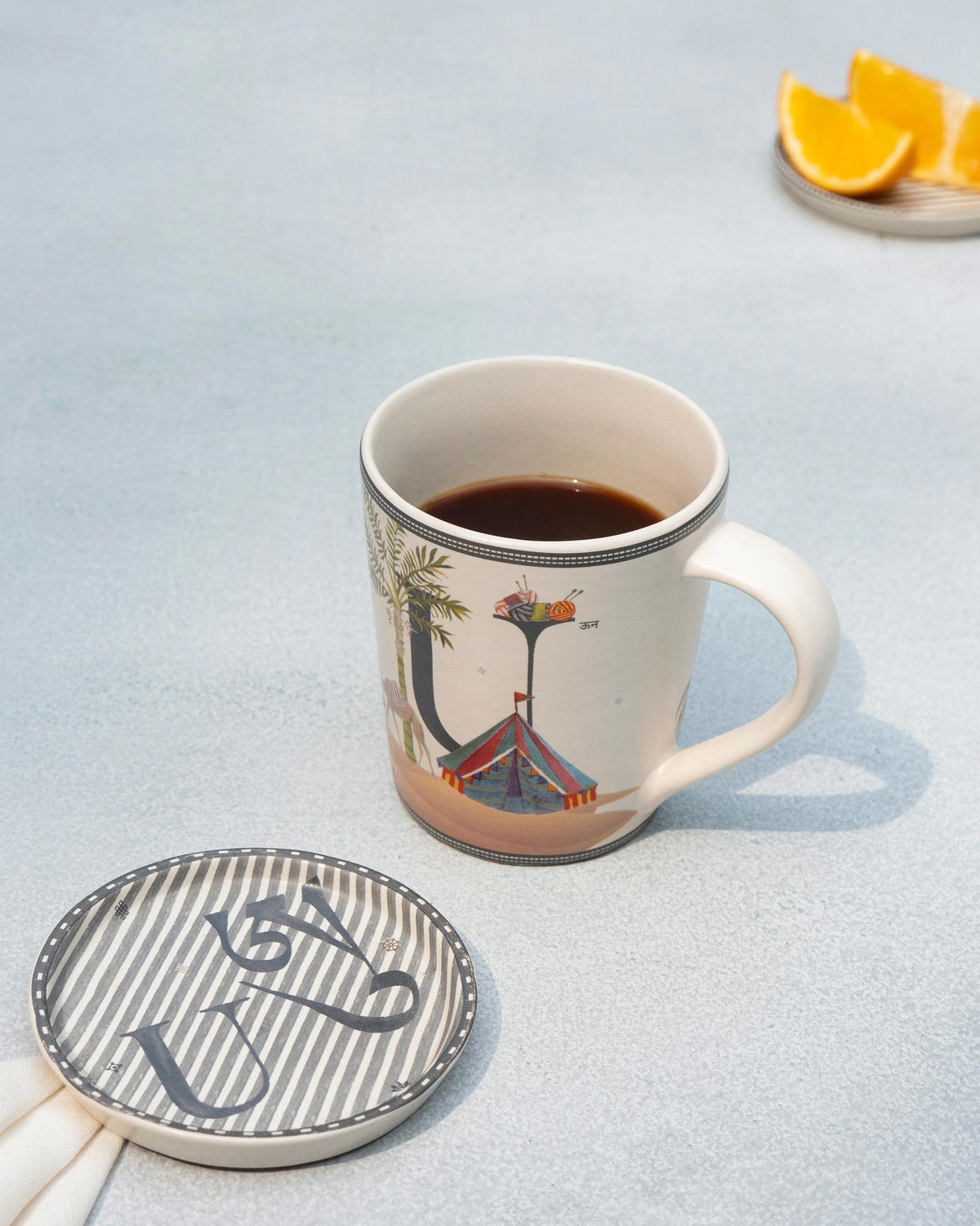 U alphabet mug and matching coaster with coffee.