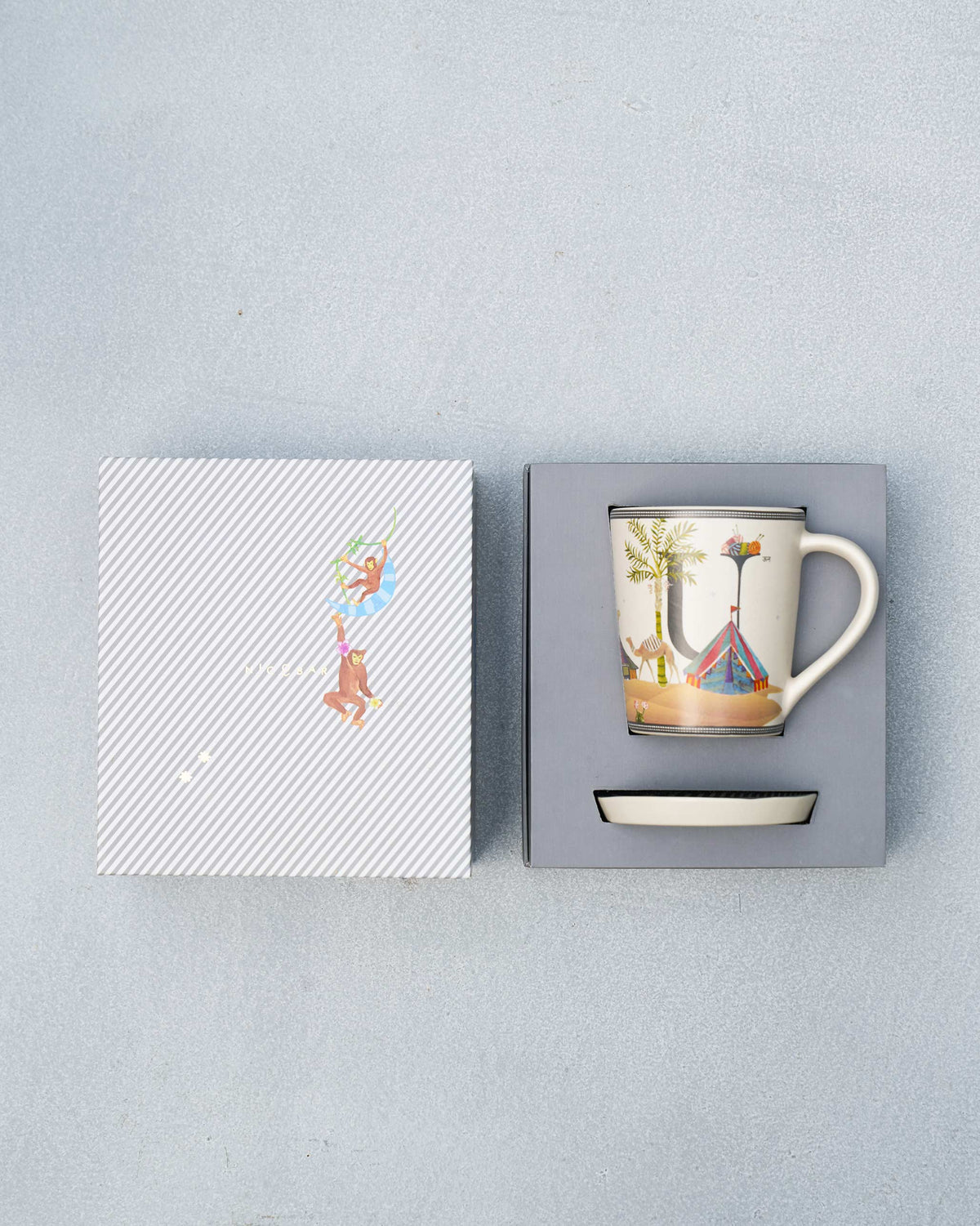 U alphabet mug and coaster in open packaging with monkey gift lid.