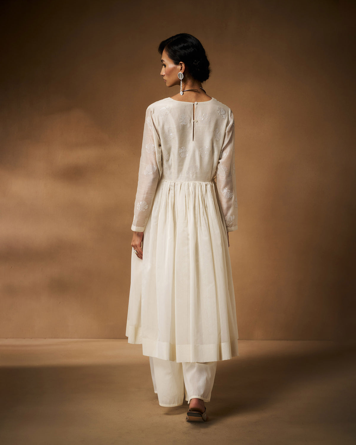 Back of a long ivory Amaya kurta with gathers and a keyhole neckline.