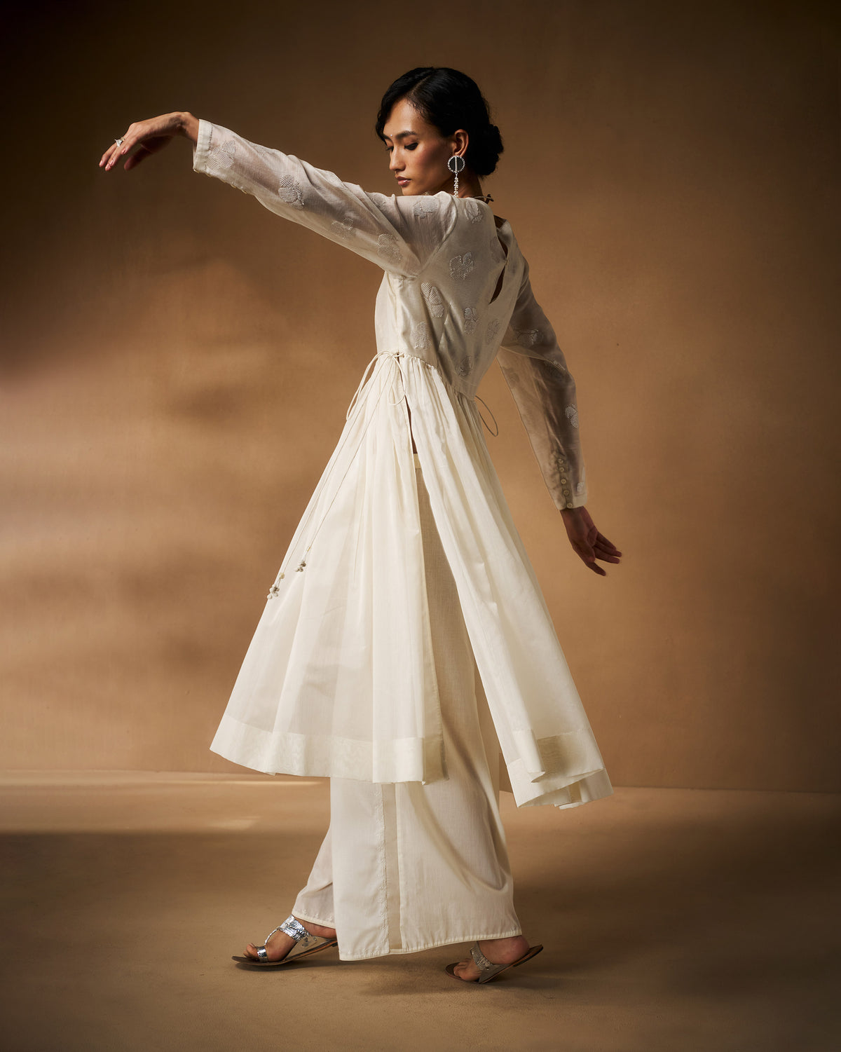 Back of an ivory Amaya kurta showing the gathered flare and keyhole.