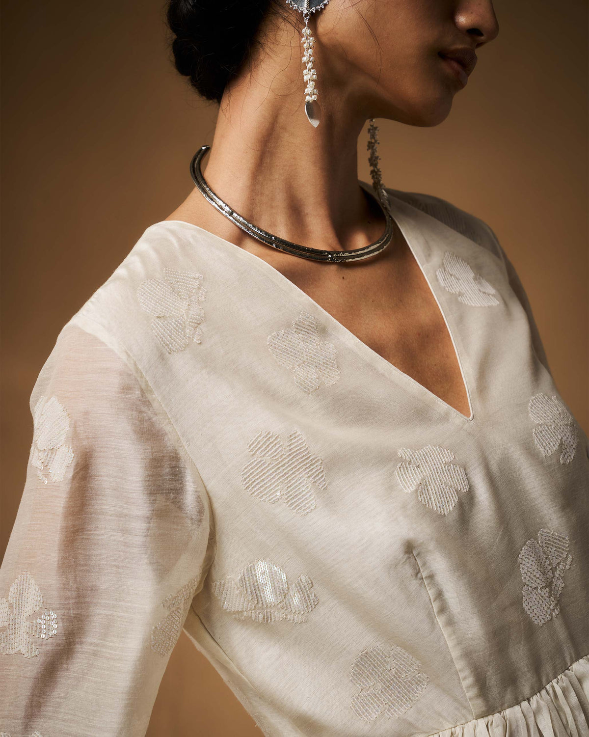 Close-up of tonal floral embroidery on an ivory Amaya kurta.