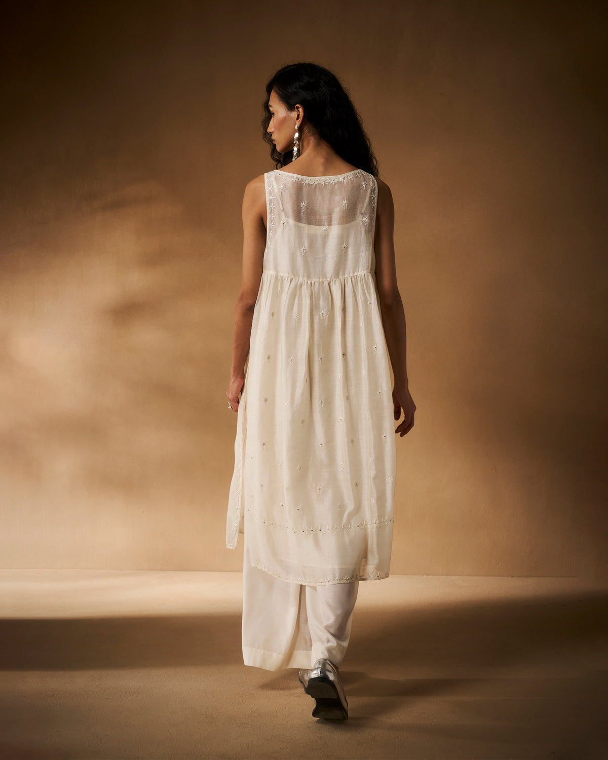 Back of an ivory chikankari Afra tunic showing the gathered waist and embroidery.