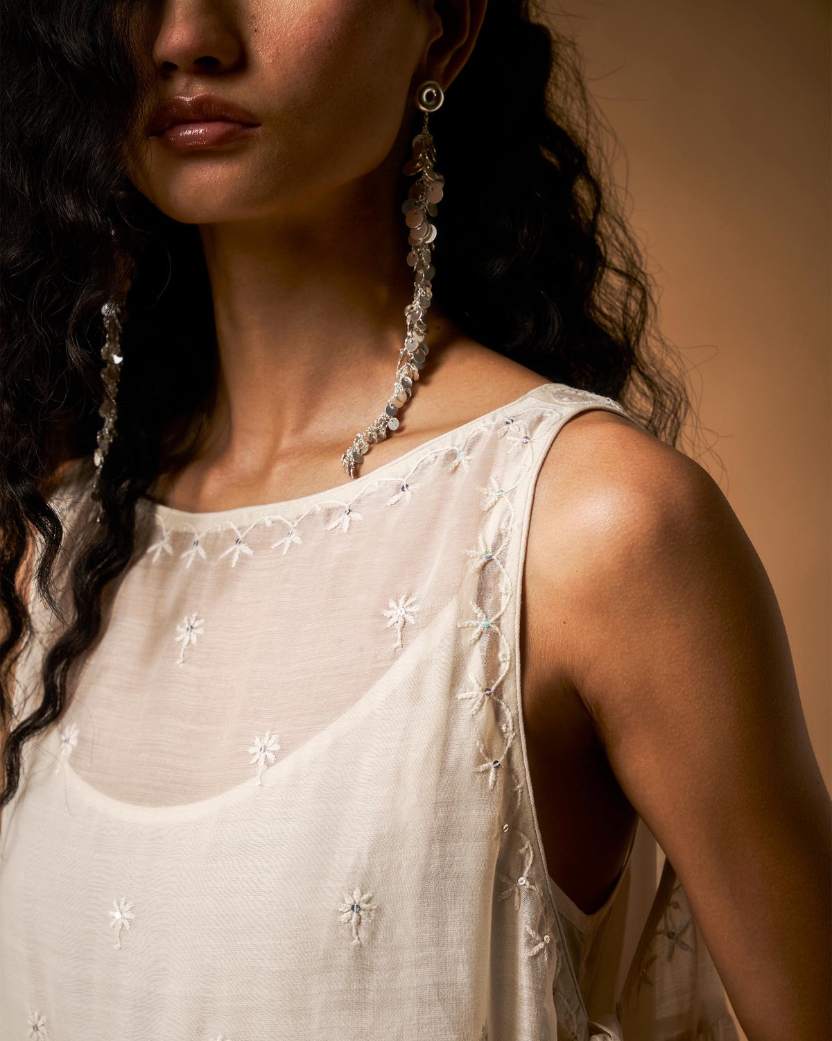 Close-up of daisy chikankari on the neckline of an ivory Afra tunic.