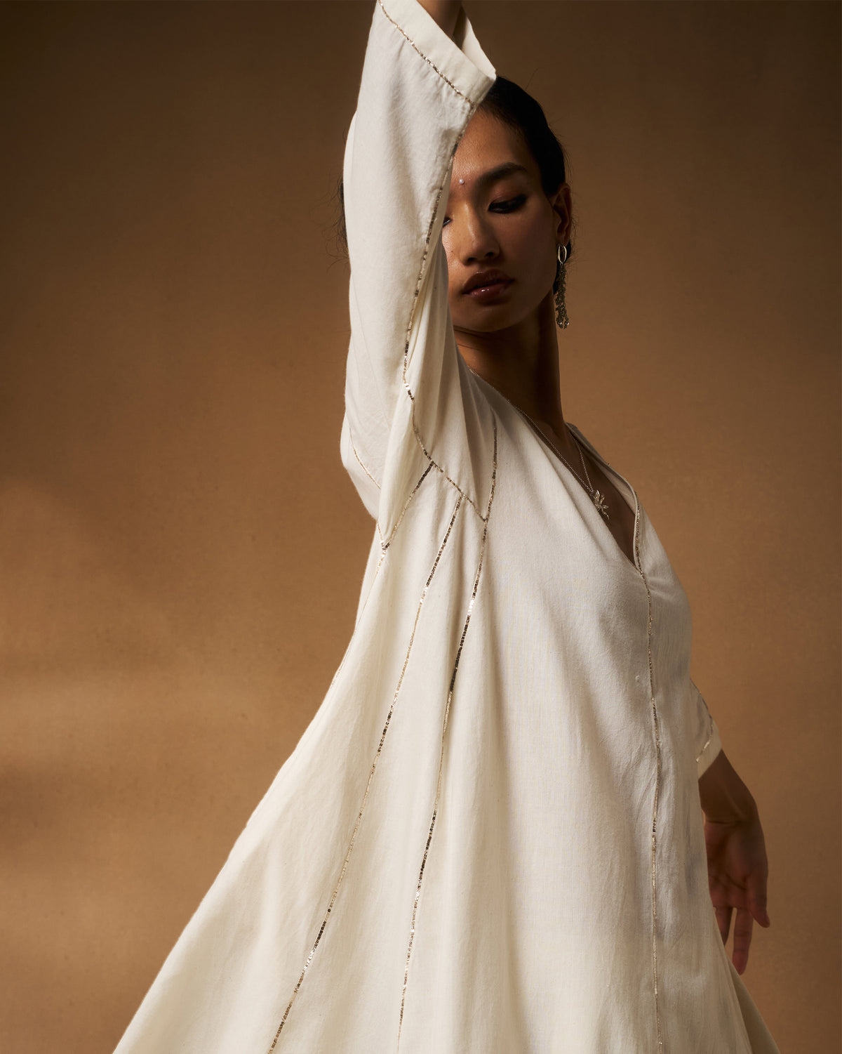 Ivory Aheli Kurta showing silver embroidery along the sleeve.