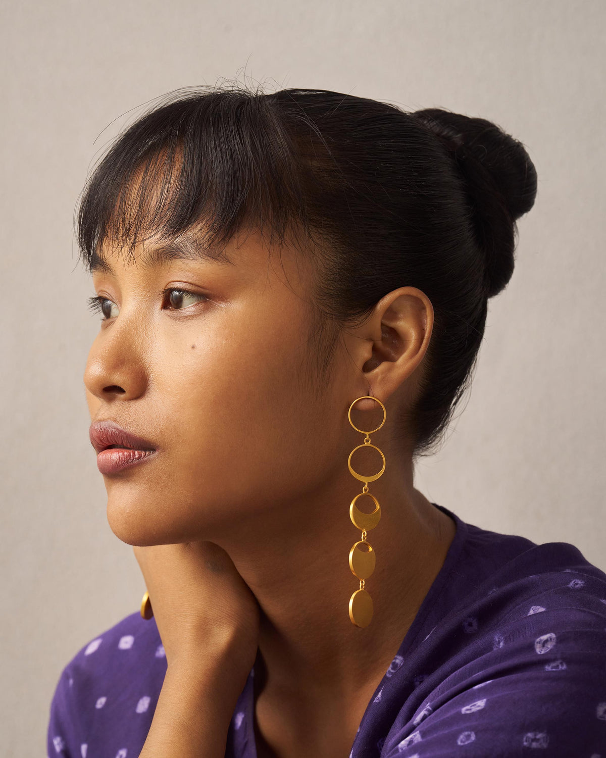 Person wearing gold Waxing Moon danglers with moon-phase drops.
