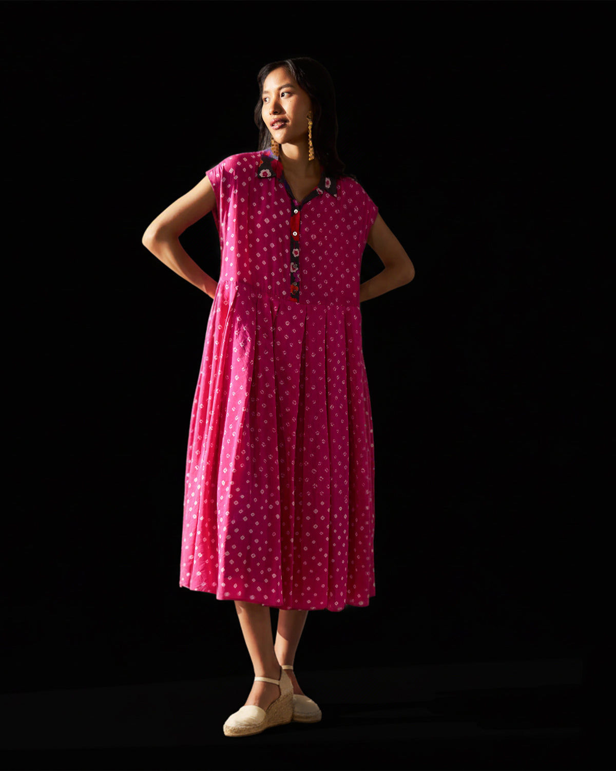 Person wearing a fuchsia Midsummer dress with a floral embroidered collar.