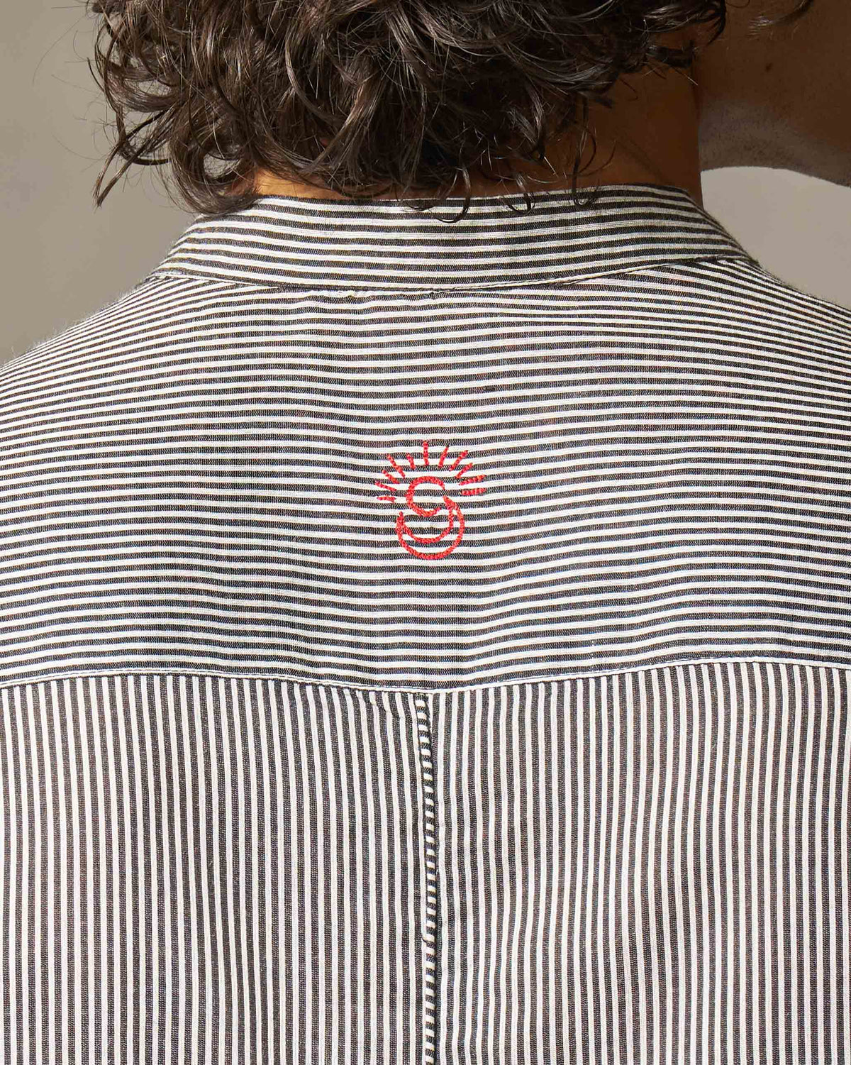 Close-up of the striped yoke and red embroidery on a Revel Kurta.